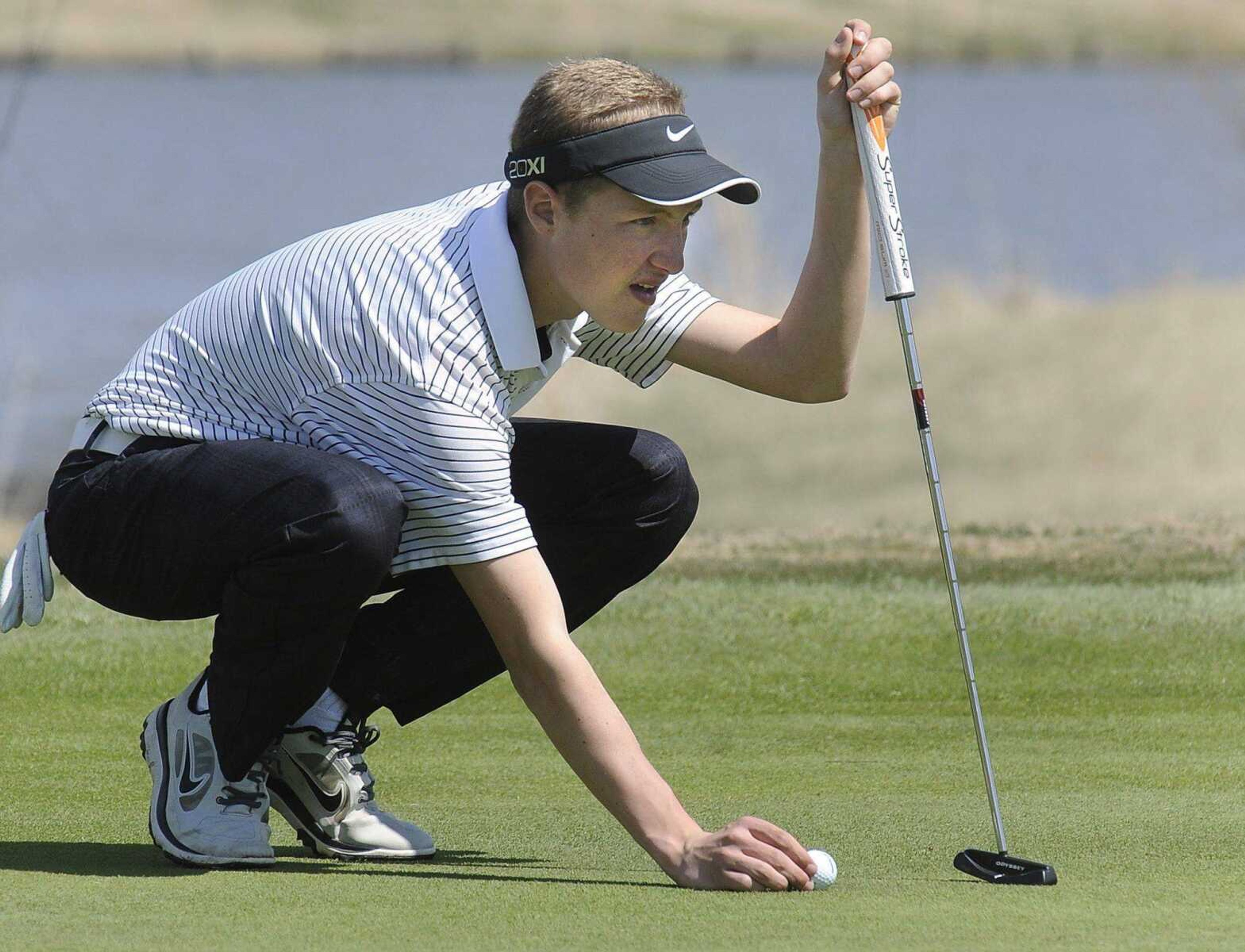 Central&#8217;s Luke Kinder places his ball for a putt during the Notre Dame Invitational.