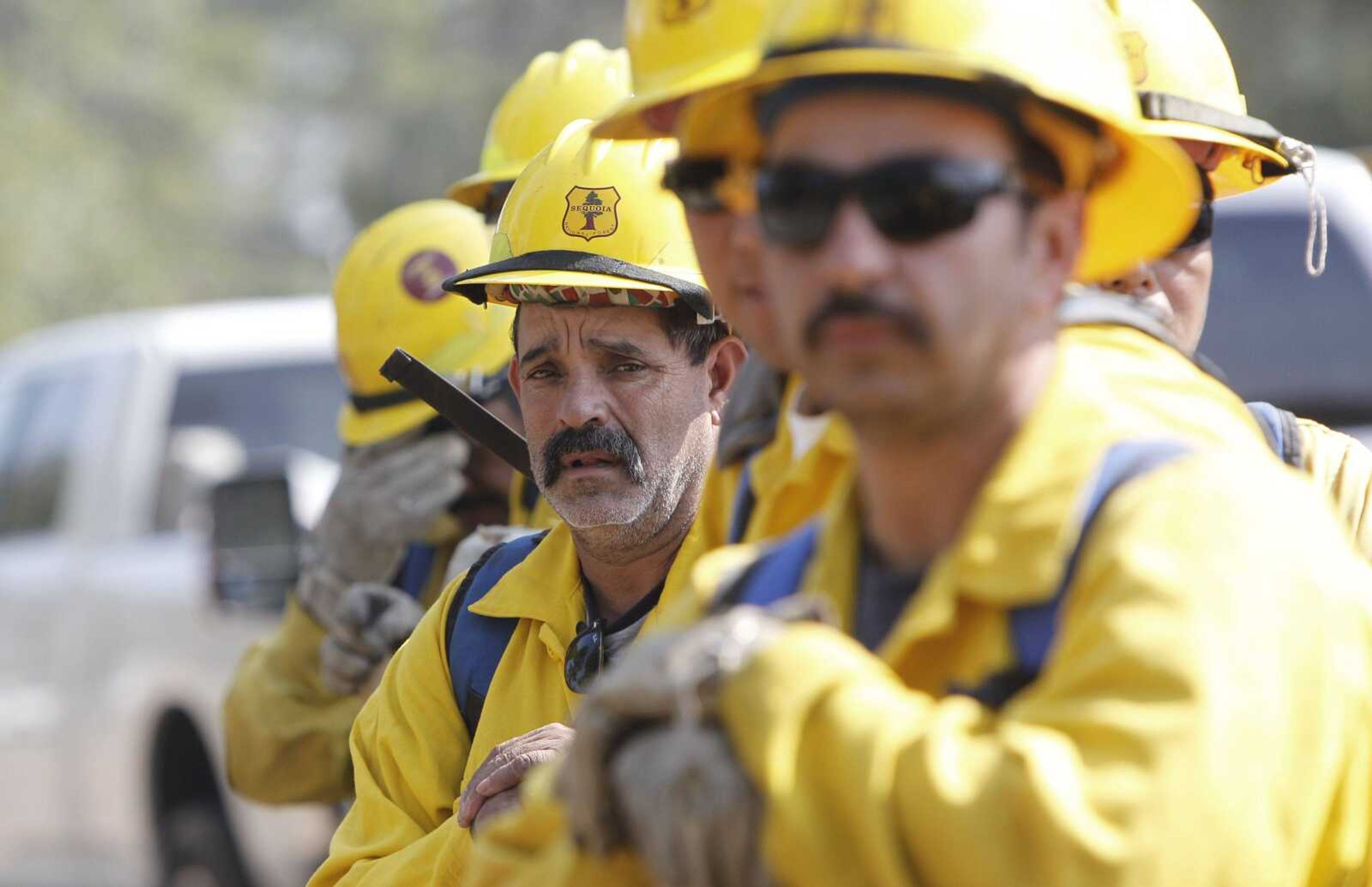 A fresh team of firefighters just arrived from the Sequoia National Forest in California lines up Friday to relieve Texas firefighters near Bastrop, Texas. (L.M. Otero ~ Associated Press)