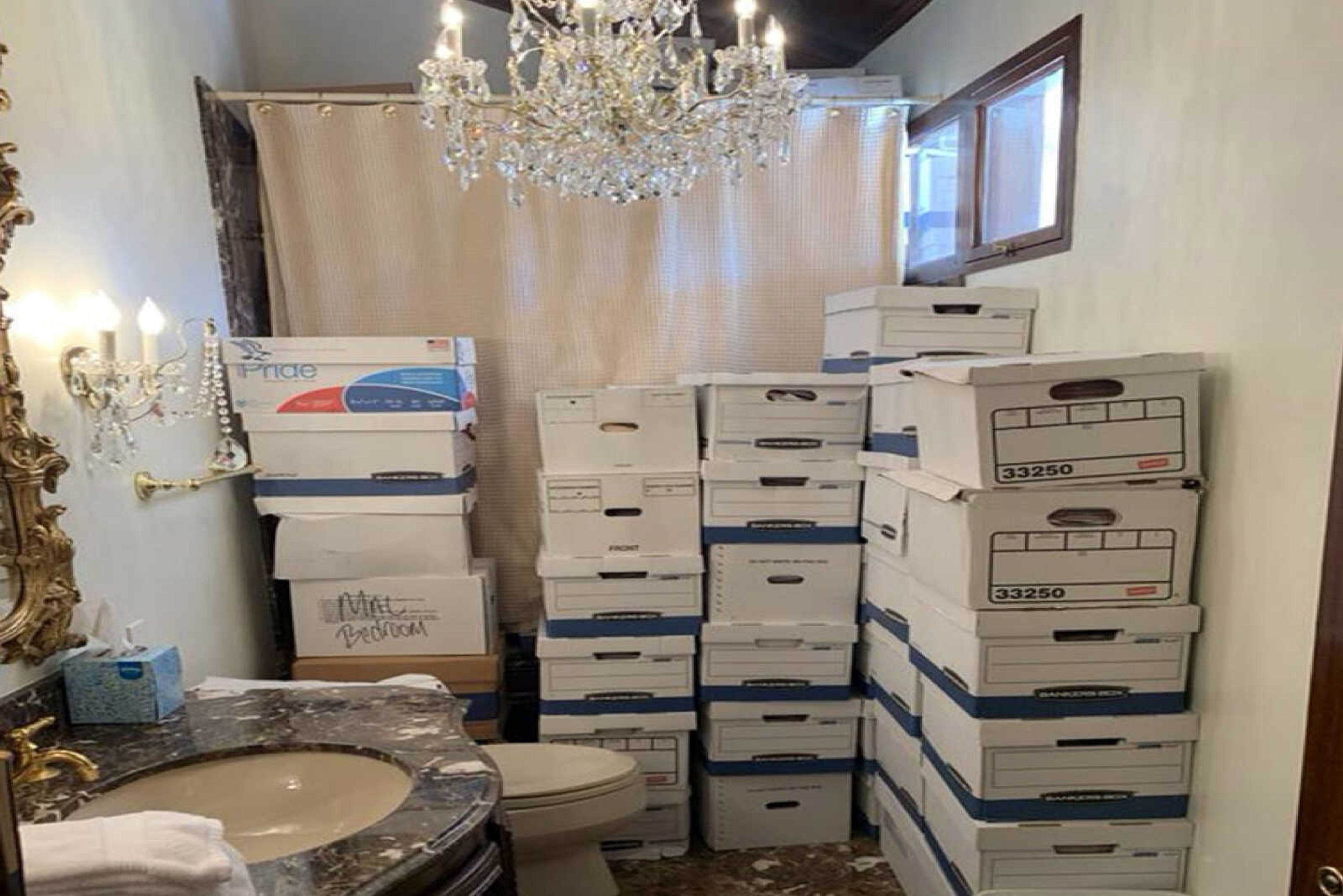 This image, contained in the indictment against former President Donald Trump, shows boxes of records stored in a bathroom and shower in the Lake Room at Trump's Mar-a-Lago estate in Palm Beach, Fla. A federal judge is set to hear arguments on whether to dismiss the classified documents prosecution of Donald Trump. His lawyers say the former president was entitled under the Presidential Records Act to keep the sensitive documents with him when he left the White House and headed to Florida.  (Justice Department via AP)