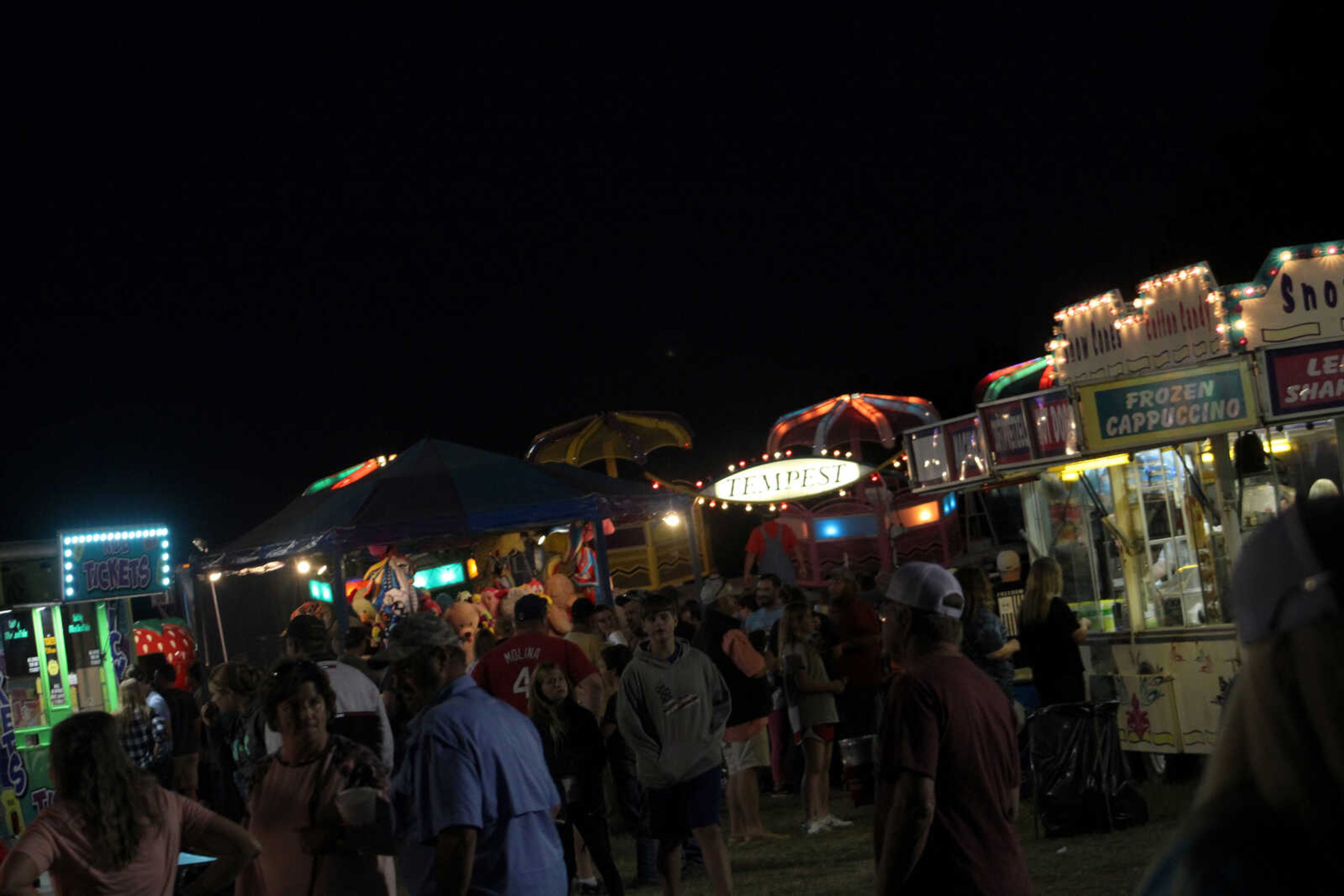 Attendees walk through the fair rides, games and food at the East Perry Community Fair Saturday, Sept. 25, 2021, in Altenburg, Missouri.