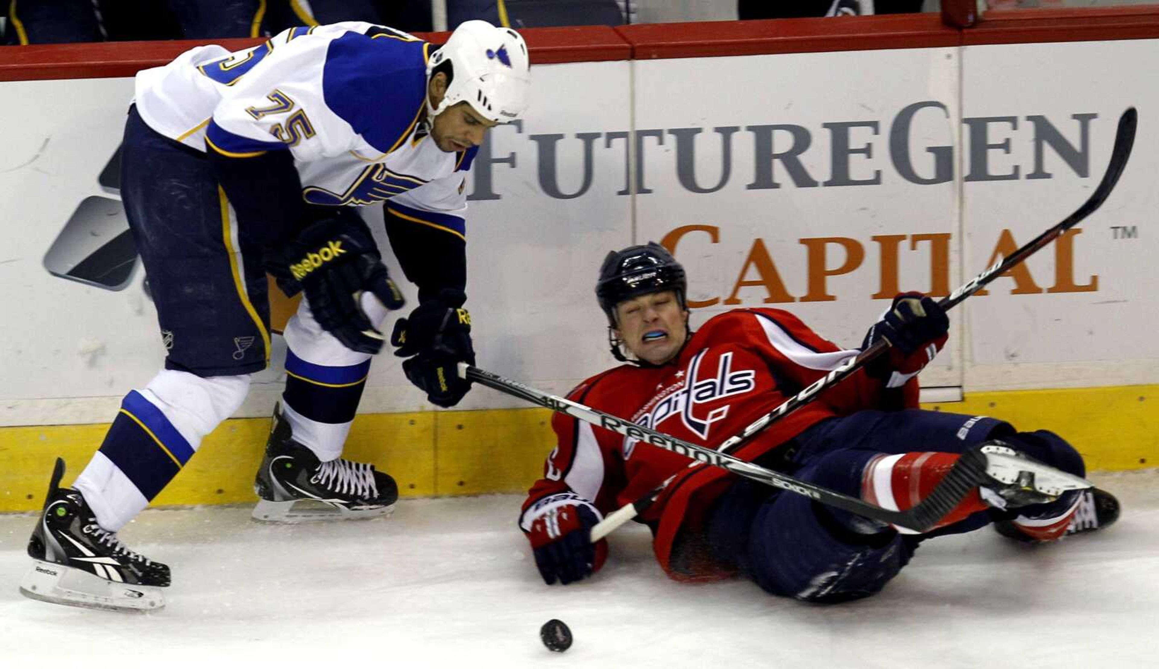 The Blues' Ryan Reaves and the Capitals' Matt Hendricks battle for the puck during the second period Thursday in Washington. (Luis M. Alvarez ~ Associated Press)