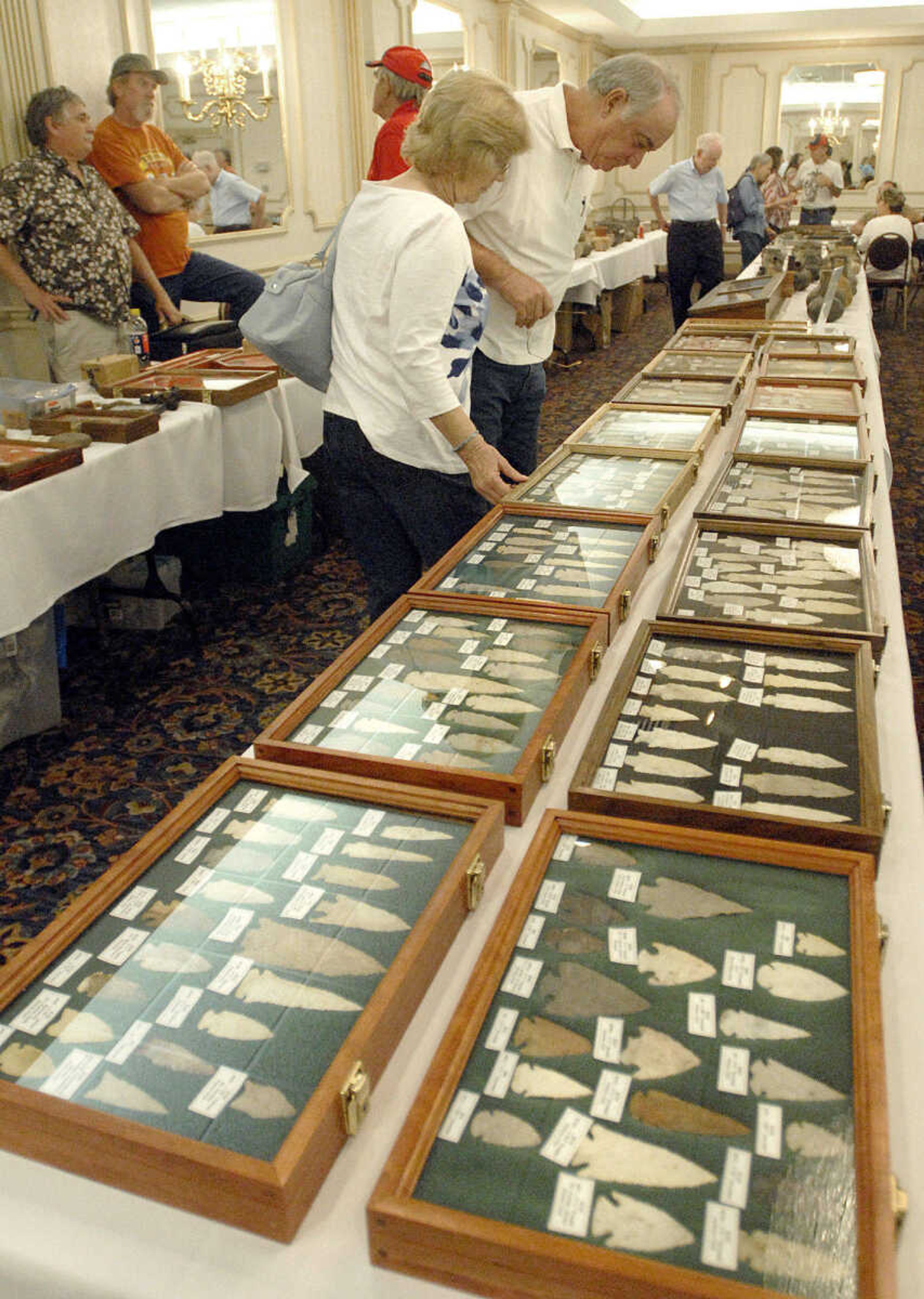 LAURA SIMON ~ lsimon@semissourian.com
Faye and Stan Myers of Commerce, Mo. look through a table of arrowheads Sunday, June 26, 2011 during the Bootheel Archeological Society exhibition at Drury Lodge in Cape Girardeau. "We've been hunting points for 40 years" Myers said.