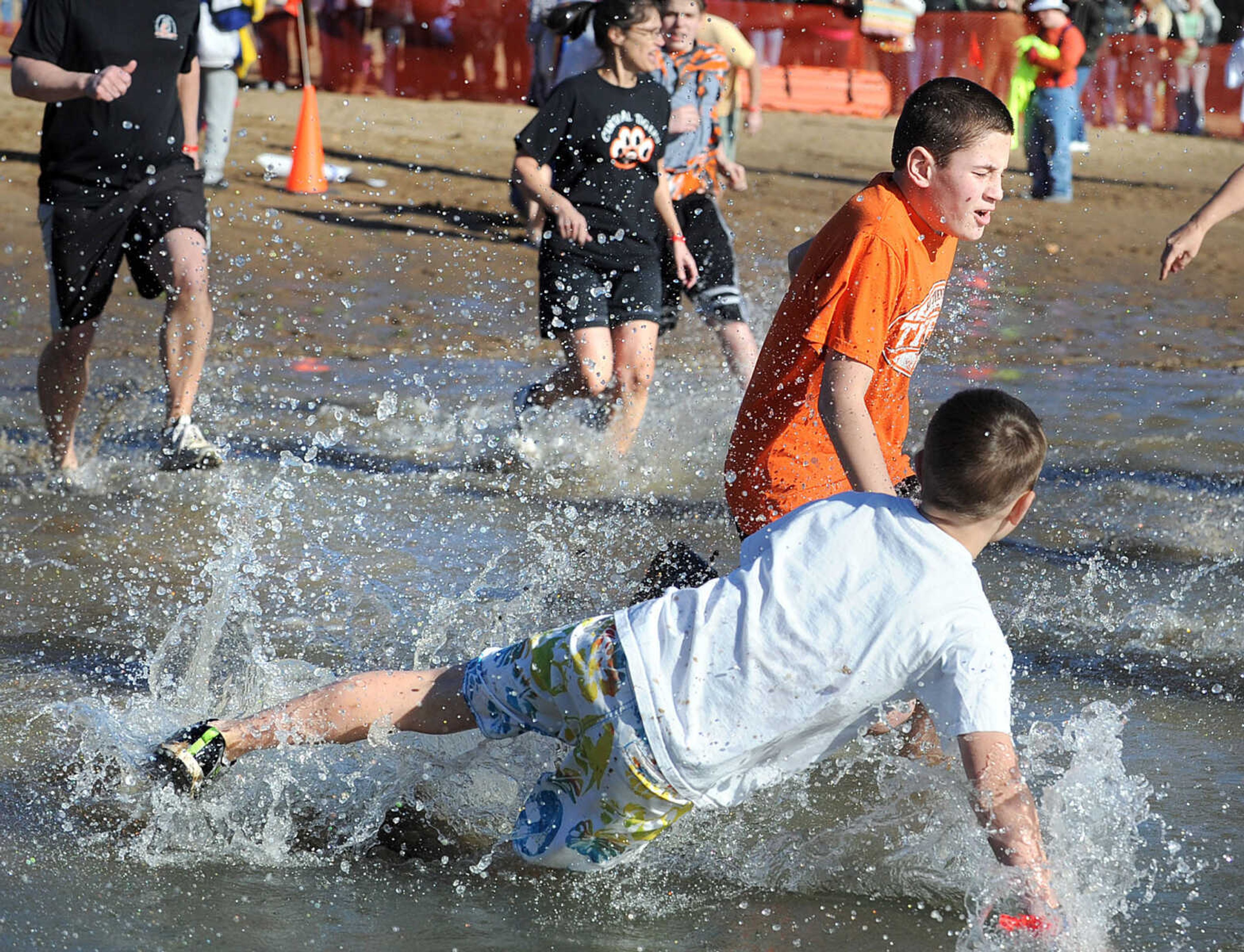 LAURA SIMON ~ lsimon@semissourian.com
People plunge into the cold waters of Lake Boutin Saturday afternoon, Feb. 2, 2013 during the Polar Plunge at Trail of Tears State Park. Thirty-six teams totaling 291 people took the annual plunge that benefits Special Olympics Missouri.