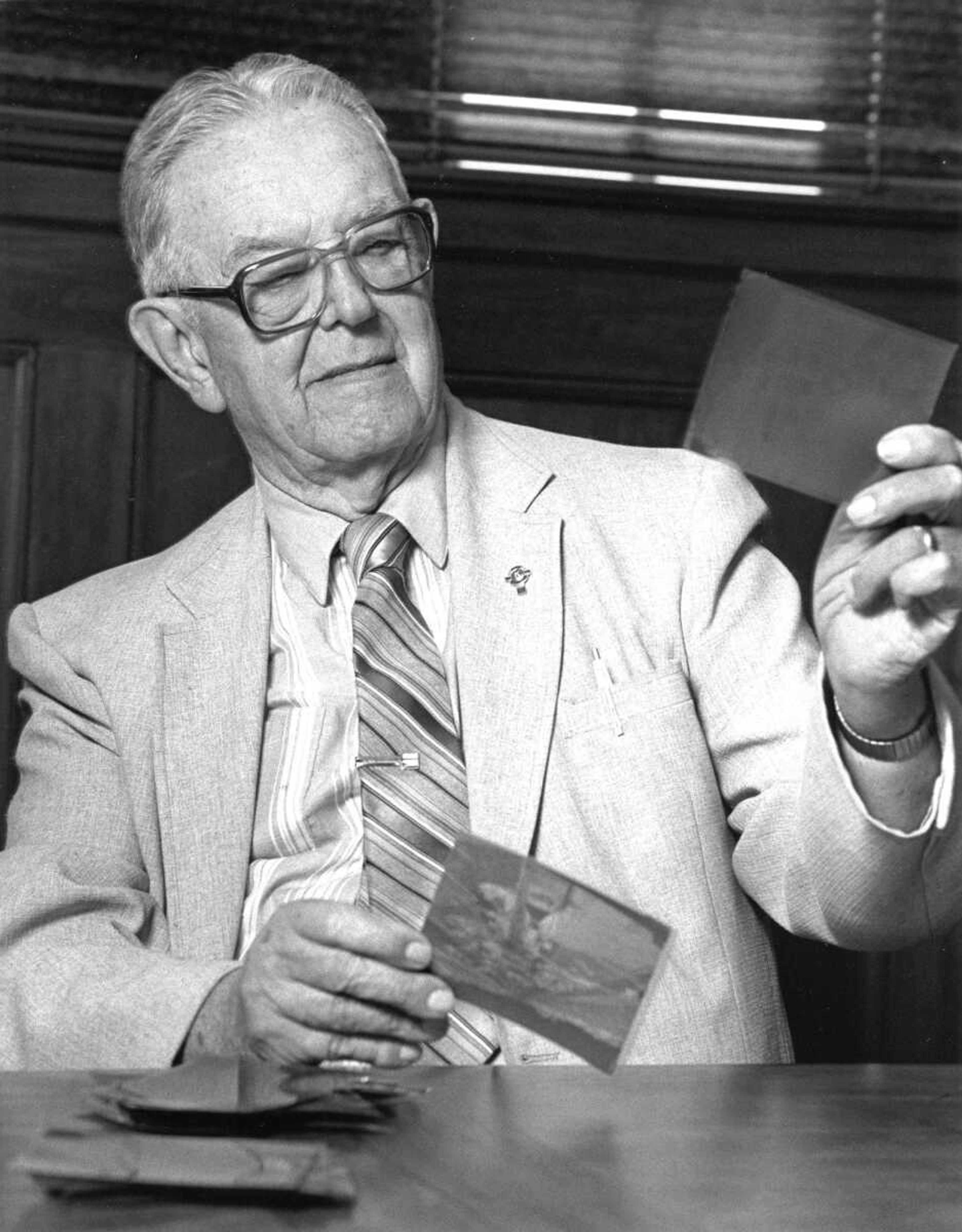 Garland D. Fronabarger looks over photograph negatives, circa 1988. Fronabarger spent nearly 60 years as a photographer at the Southeast Missourian.