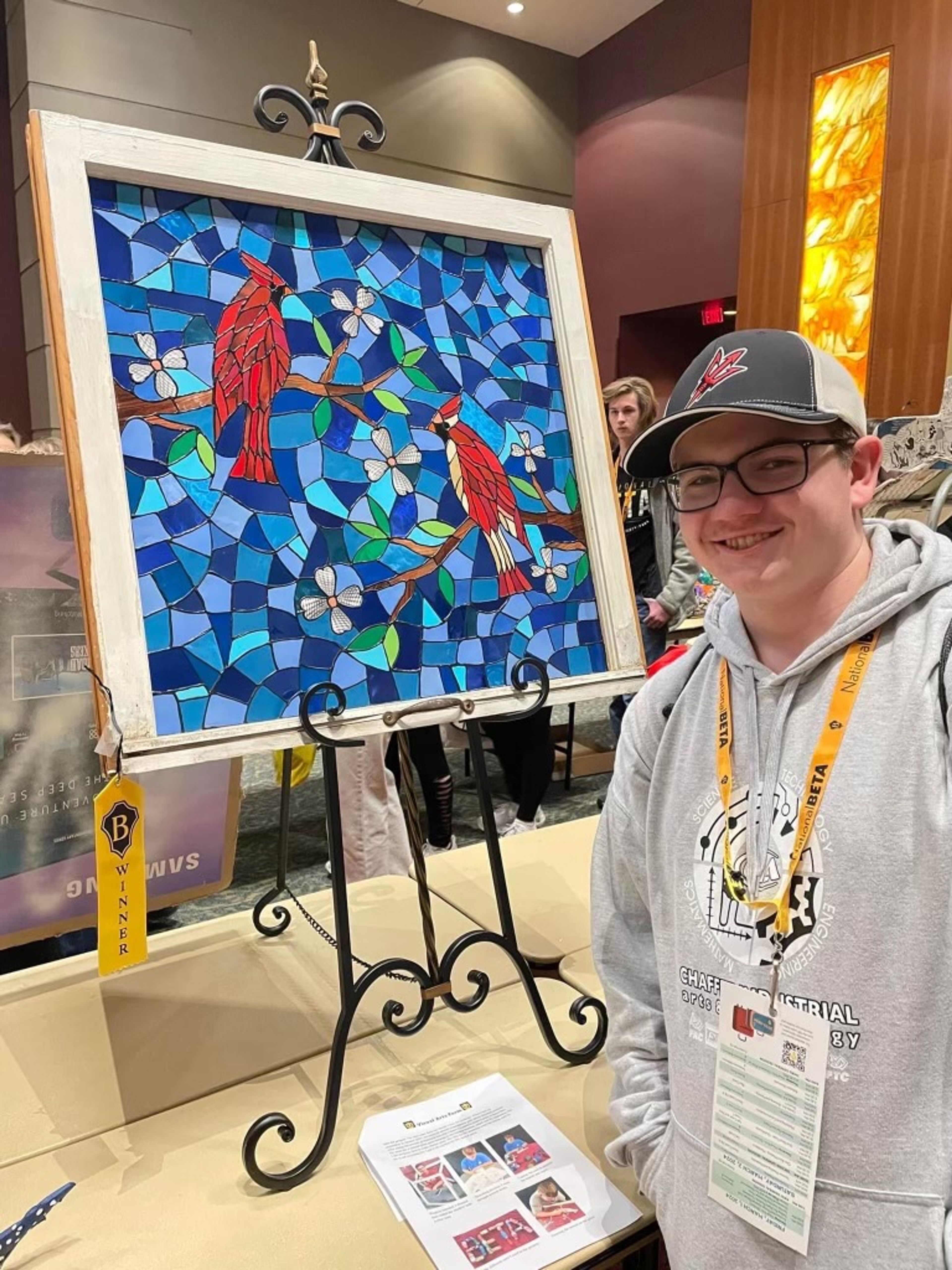 Eli Nix stands next to his recyclable art project he won first place with. 