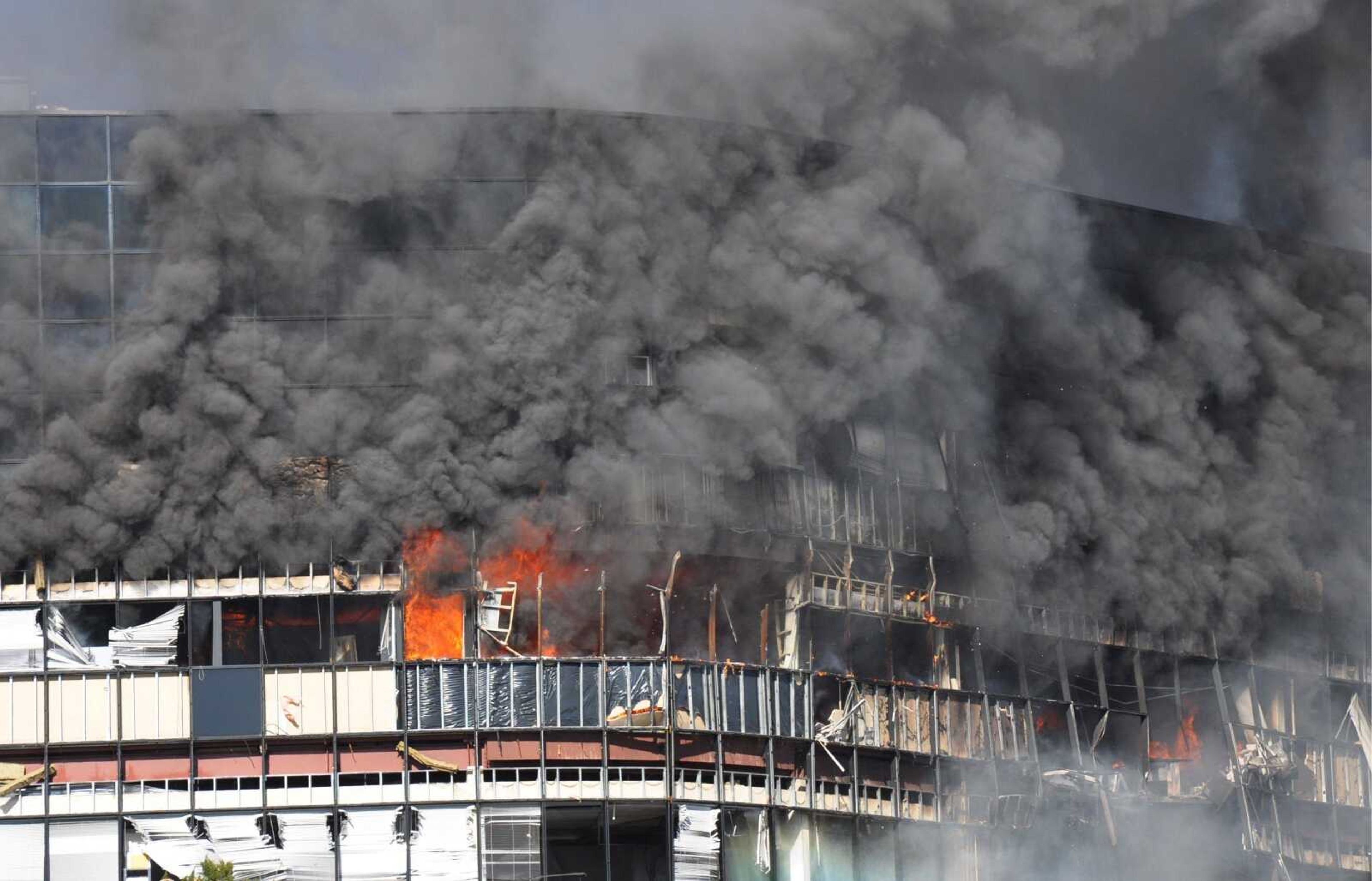 In this photo provided by Trey Jones, smoke billows from a seven-story building  in Austin, Texas after a small private plane crashed into it Thursday Feb. 18, 2010. (AP Photo/Trey Jones)