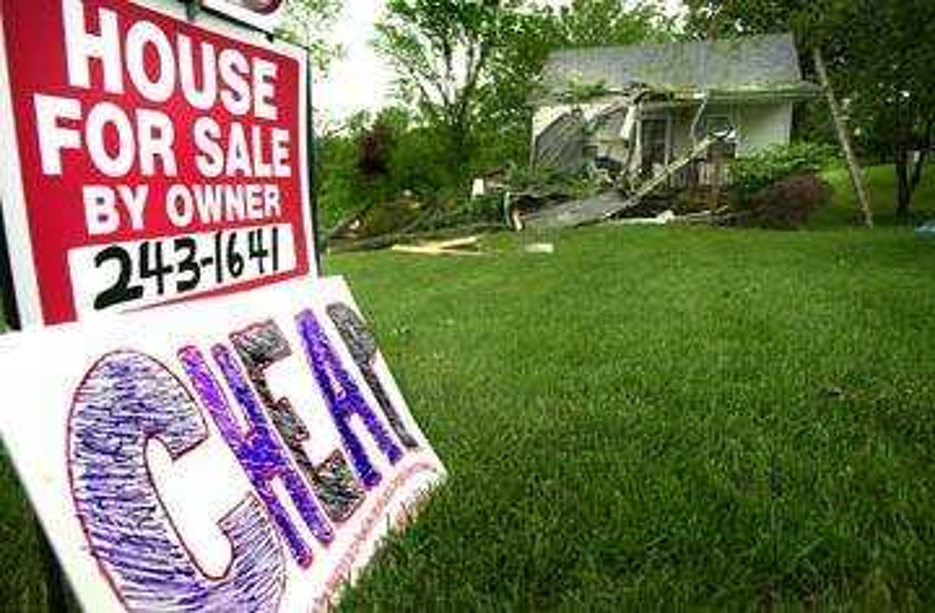 409 North Shawnee Blvd was hit hard by the storm on Tuesday night.  Although the house was already for sale by owner, Kathy Fausett and family put out the "cheap" sign as a way of laughing their way through the disaster.