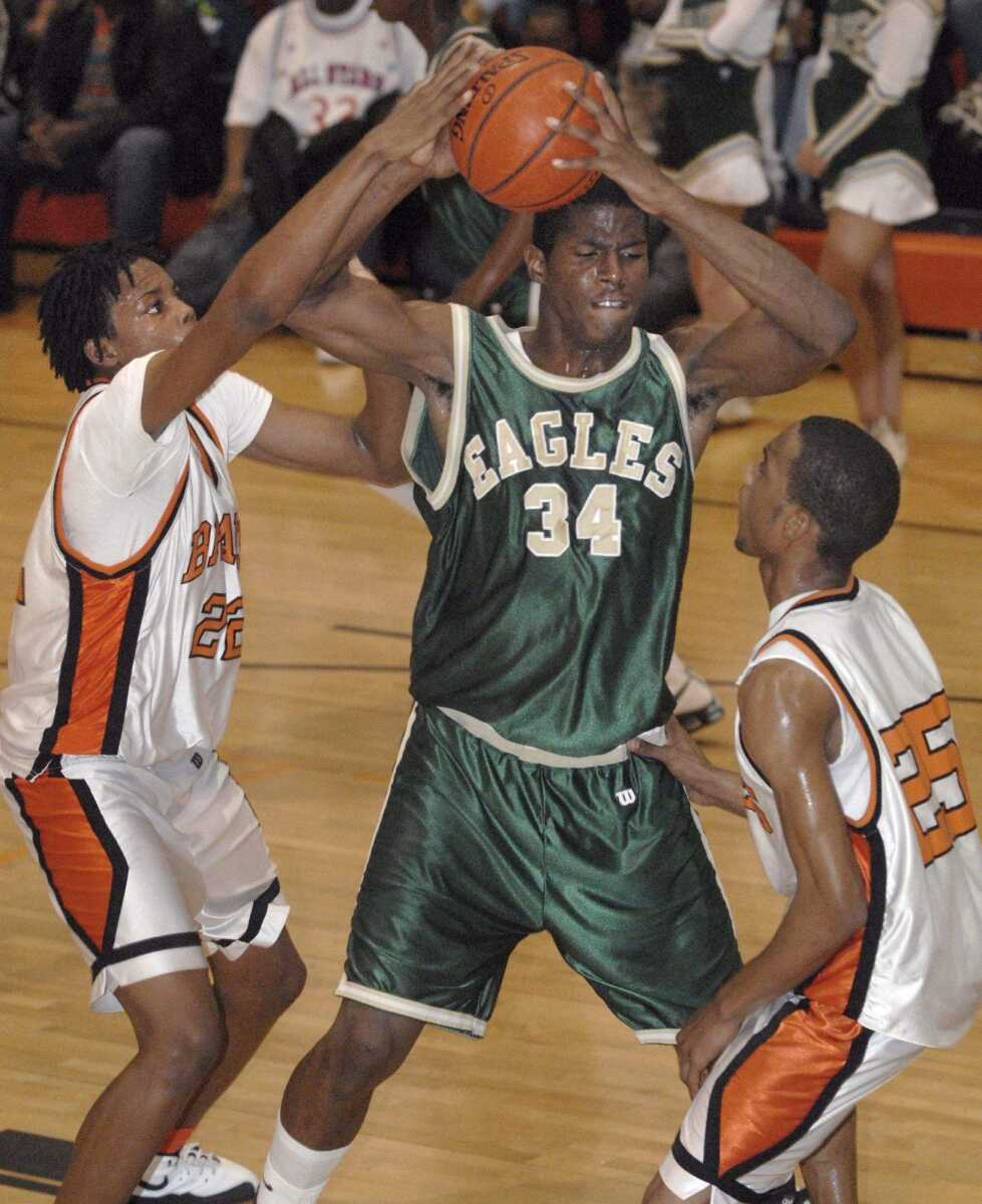 FRED LYNCH ~ flynch@semissourian.com
New Madrid County Central's Kony Ealy grabs a rebound away from Scott County Central's Desmin Williams, left, and Randy Timmons in the second quarter Friday at Scott County Central.