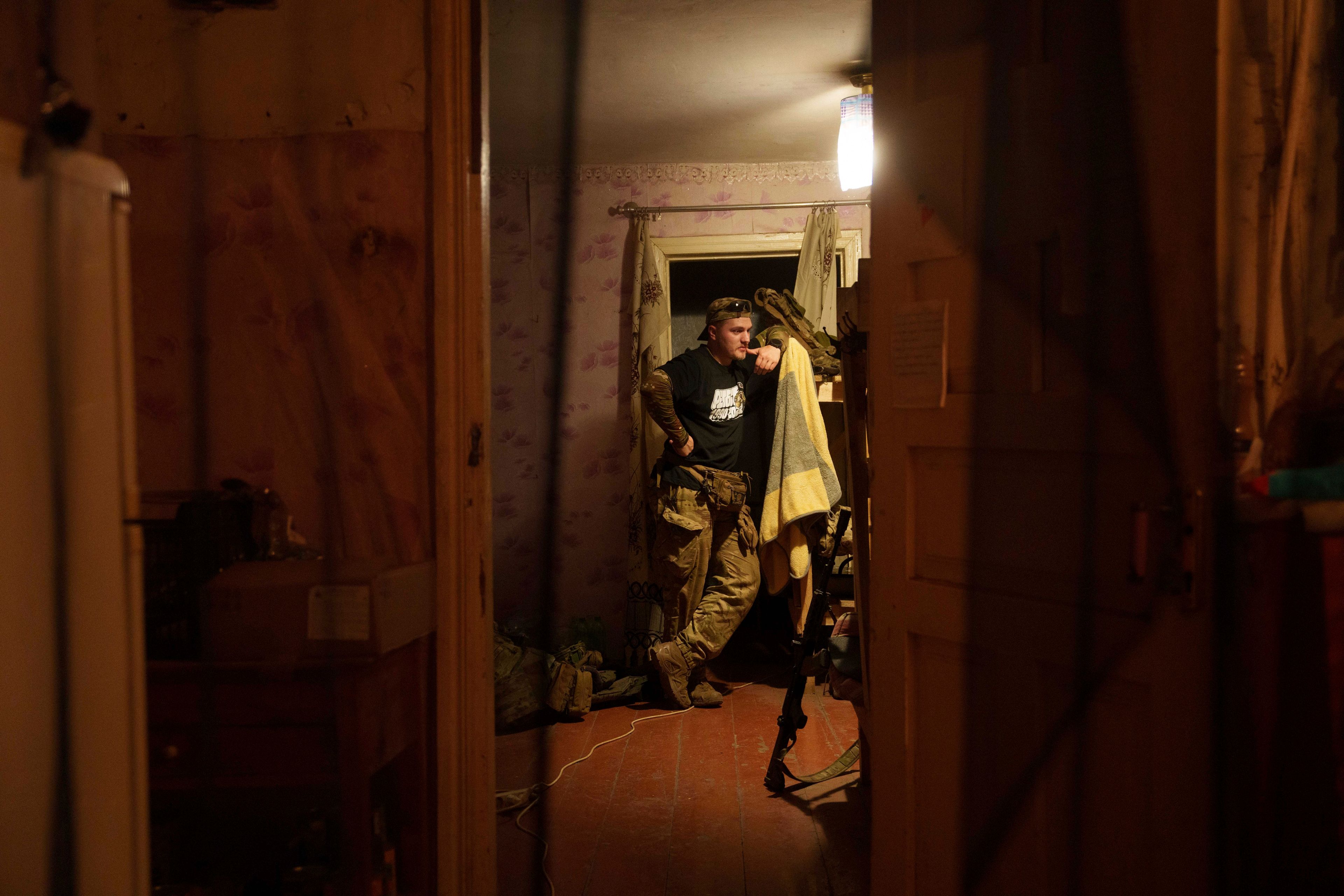 Ukrainian serviceman known by the call sign "Tankist" of the 3rd assault brigade stands in a room of a house not far from the frontline in Kharkiv region, Ukraine, Sunday Sept. 22, 2024. (AP Photo/Evgeniy Maloletka)