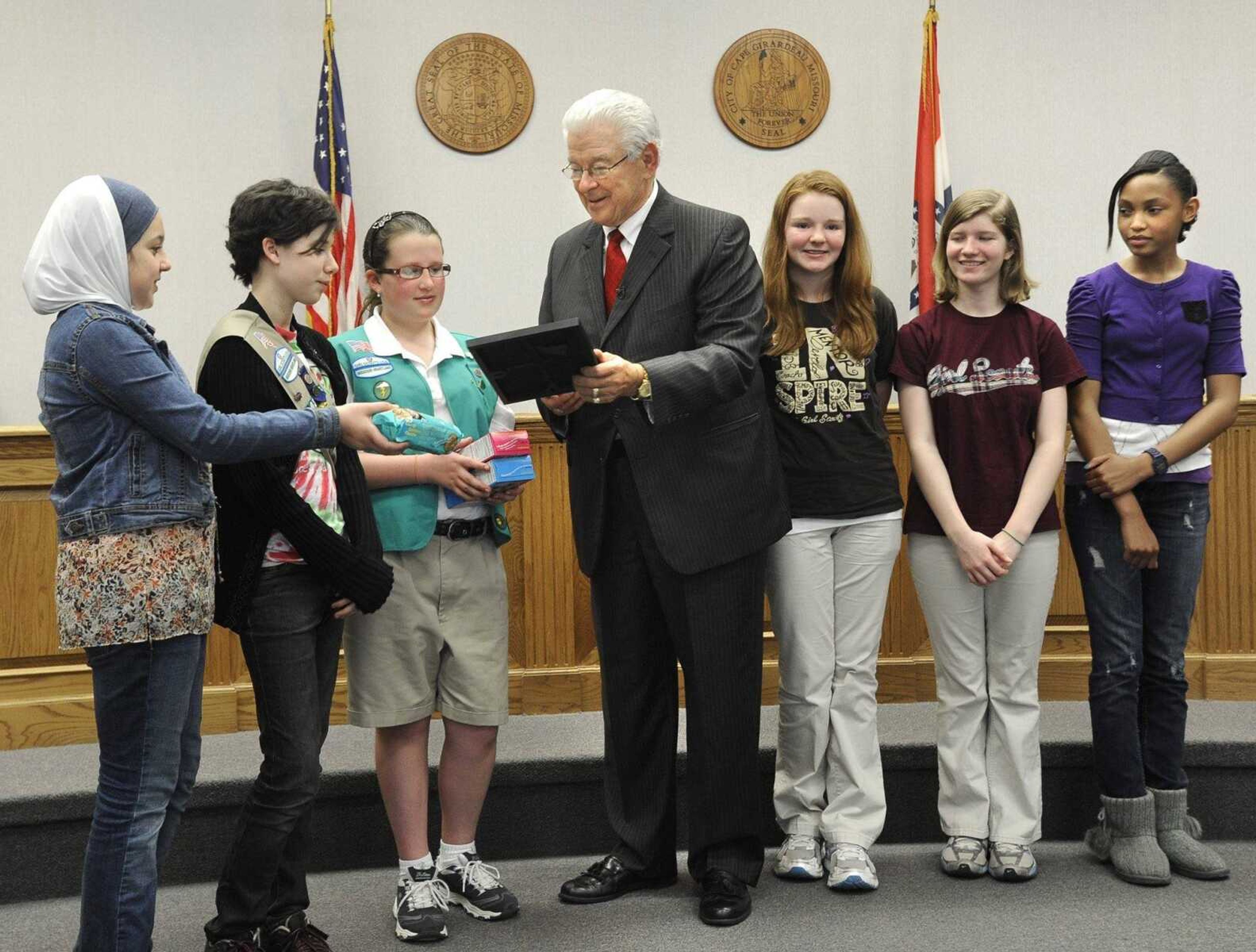 Mayor Harry Rediger presents a proclamation Monday, March 12, 2012 recognizing the 100th anniversary of the Girls Scouts to local scouts, from left, Shadan Roumany, Corri Brown, Maria Enderle, Tesla Scott, Sarene Allen and Jada Ayers. (Fred Lynch)