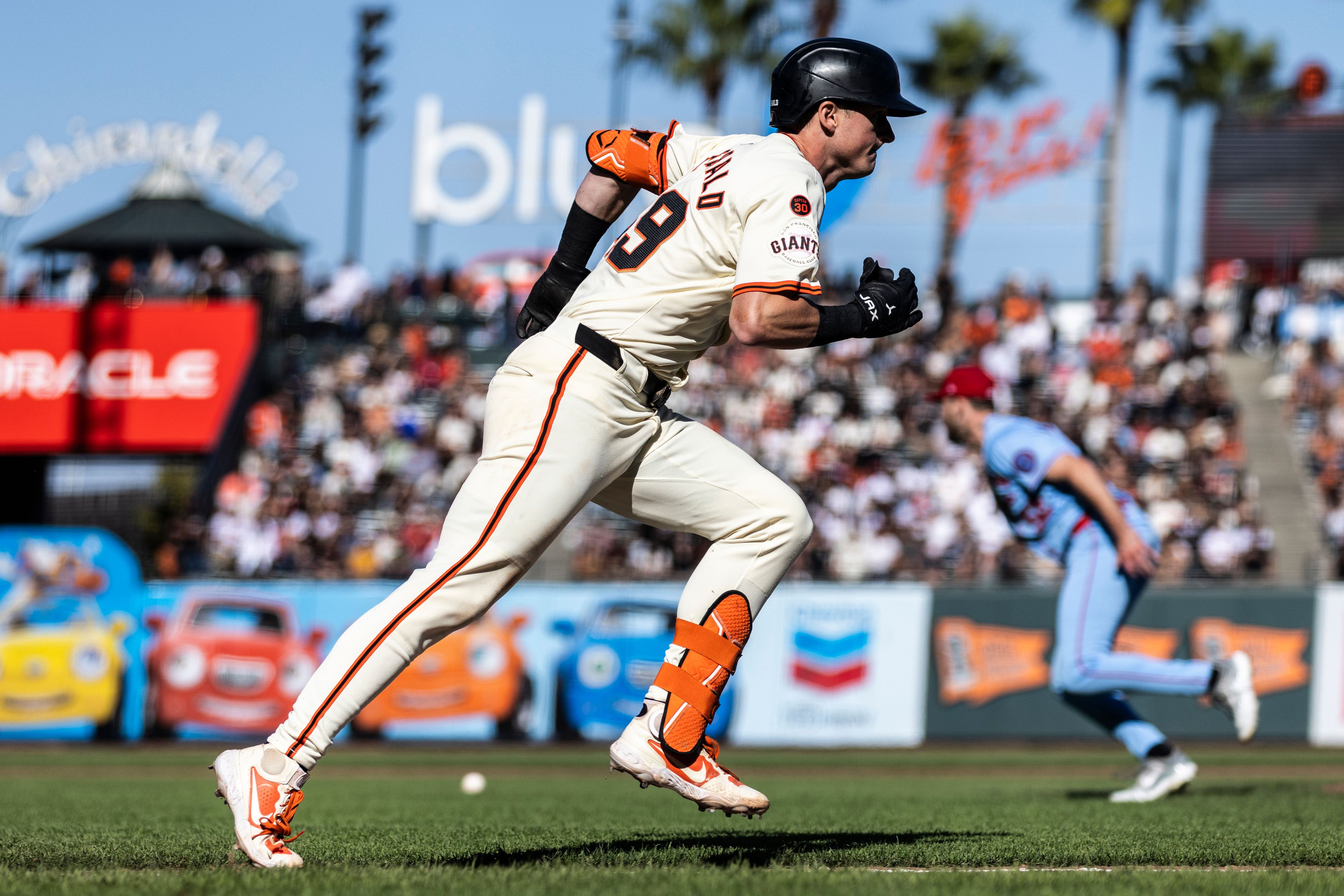 San Francisco Giants' Tyler Fitzgerald (49) sprints towards first on an infield single during the eighth inning of a baseball game against the St. Louis Cardinals in San Francisco, Saturday, Sept. 28, 2024. (Stephen Lam/San Francisco Chronicle via AP)