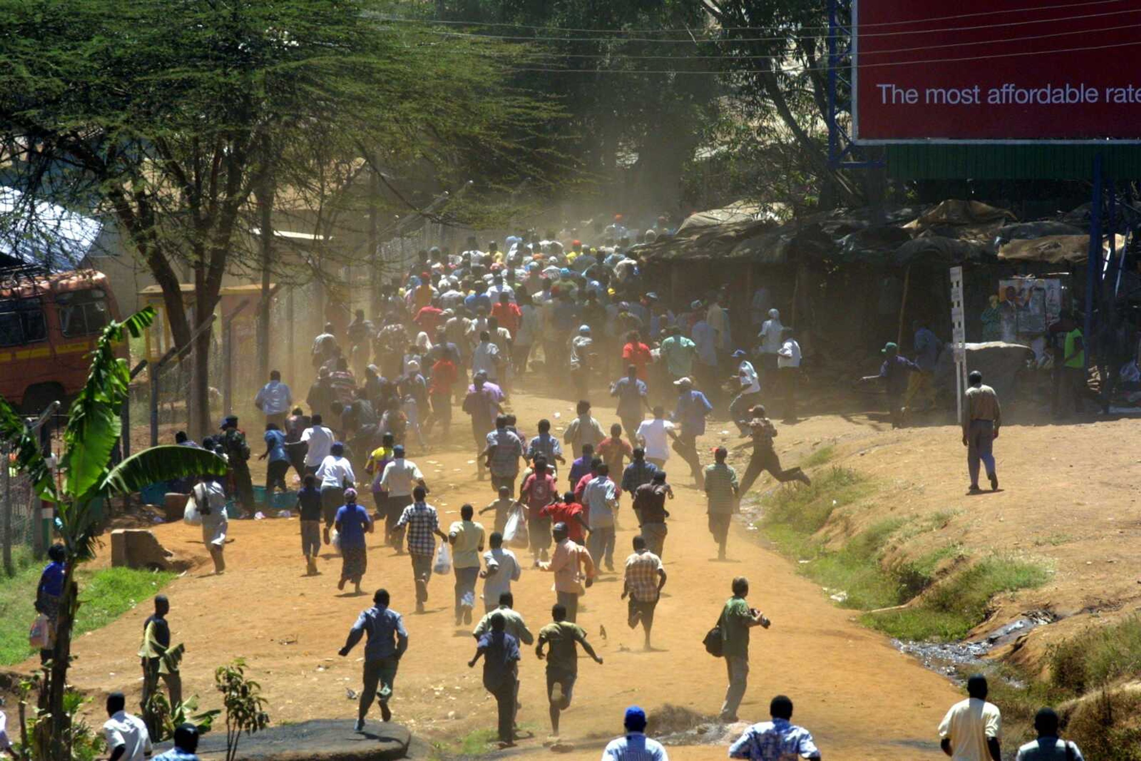 Protesters ran away Saturday as riot police chased them in Kibera slums. A government statement said Saturday that Kenya's President Mwai Kibaki is ready to form "a government of national unity" to help resolve disputed elections that caused deadly riots. (KHALIL SENOSI ~ Associated Press)