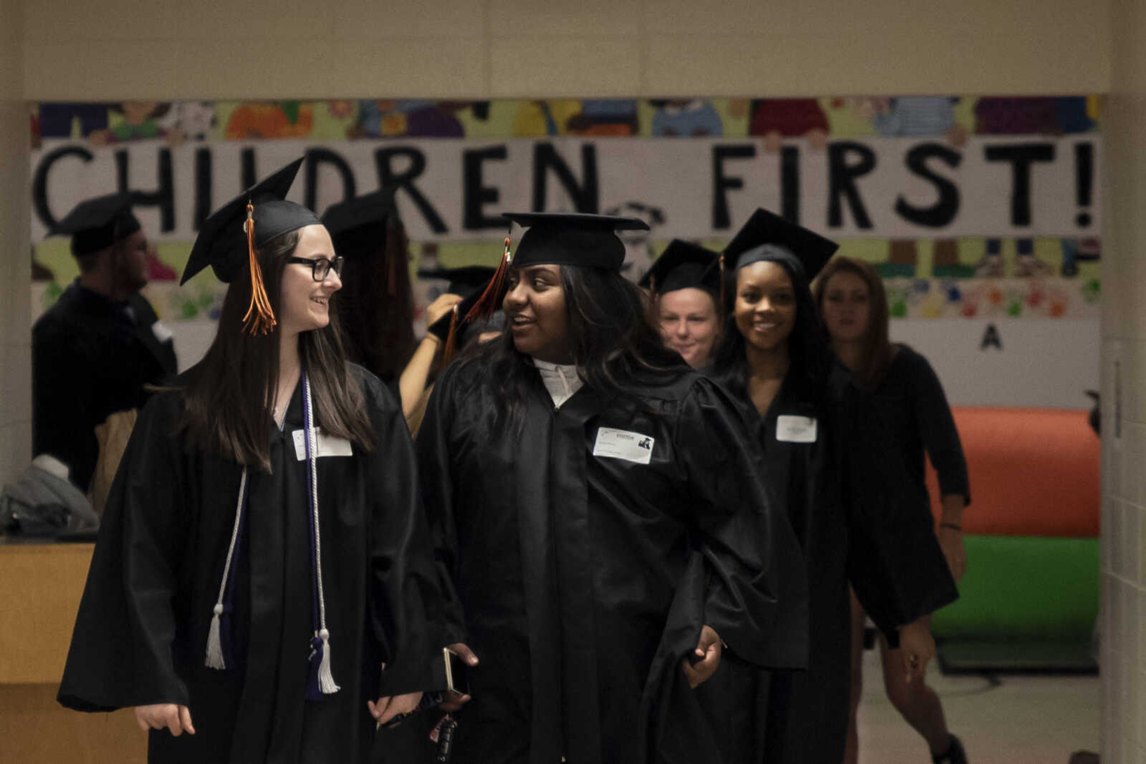 Emily Medlock, left, walks through the halls of Clippard Elementary School with her friend Taylor Driver during the grad walk Friday, May 10, 2019, in Cape Girardeau. The grad walk is an opportunity for graduates to visit the elementary school they attended and visit with teachers who might still be working at that building.