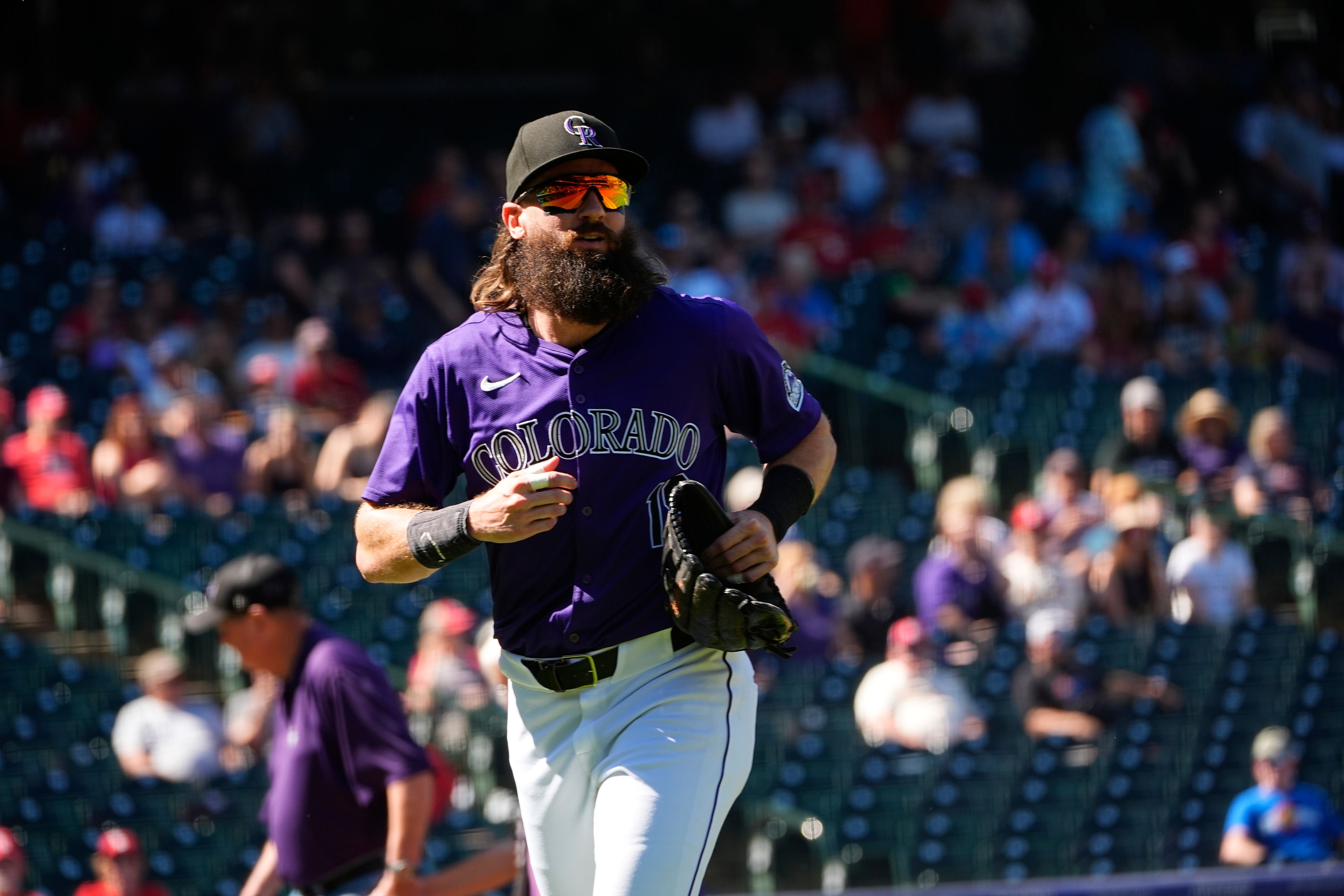 Colorado Rockies' Charlie Blackmon heads out to warm up before a baseball game against the St. Louis Cardinals Thursday, Sept. 26, 2024, in Denver. (AP Photo/David Zalubowski)