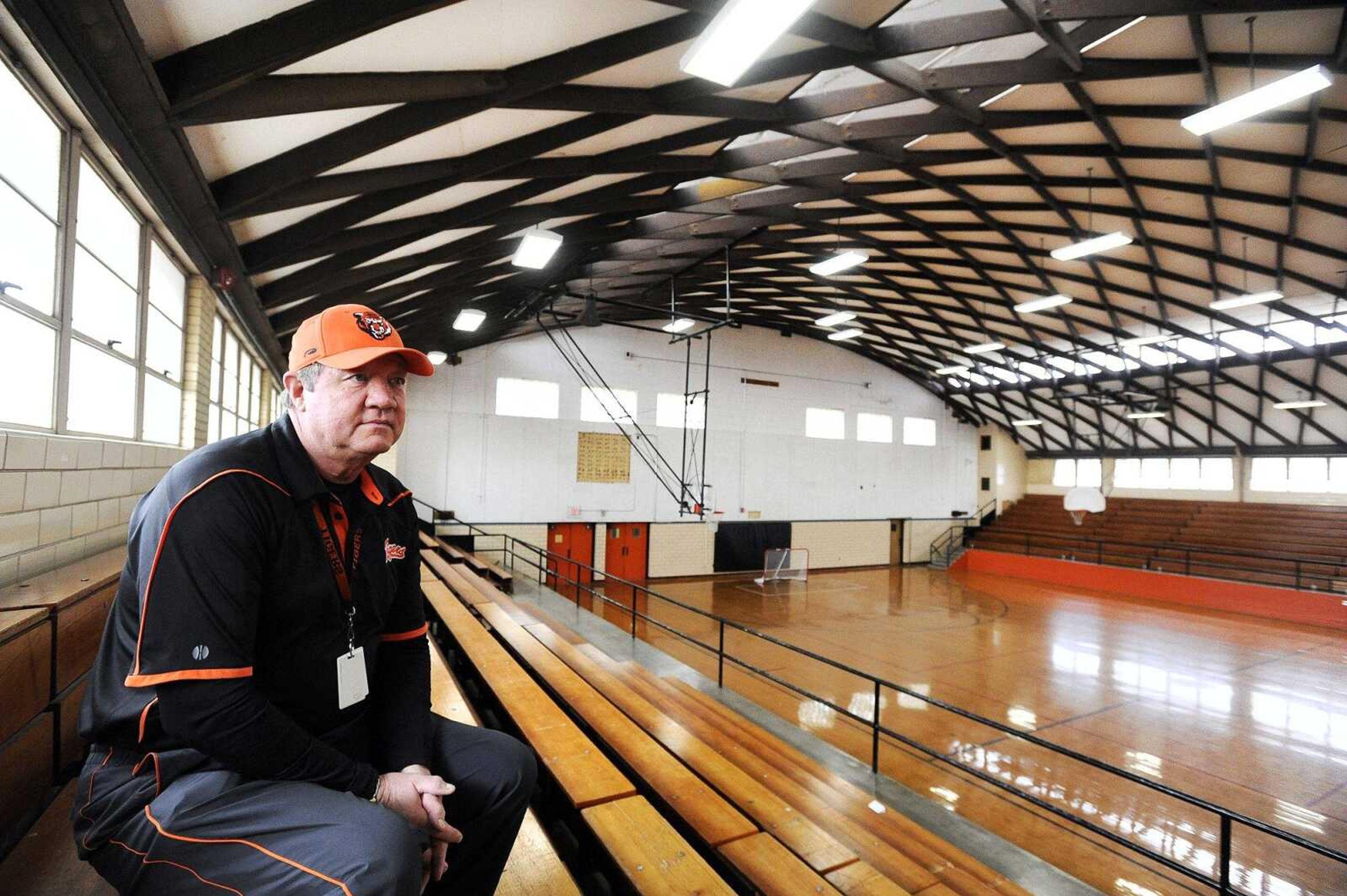 Coach Terry Kitchen sits on the bleachers inside the Central Junior High School gymnasium Tuesday morning in Cape Girardeau. Kitchen, a Central class of 1970 alumnus, also has been an employee of Cape Girardeau school district for 38 years and holds many memories of the old gymnasium.