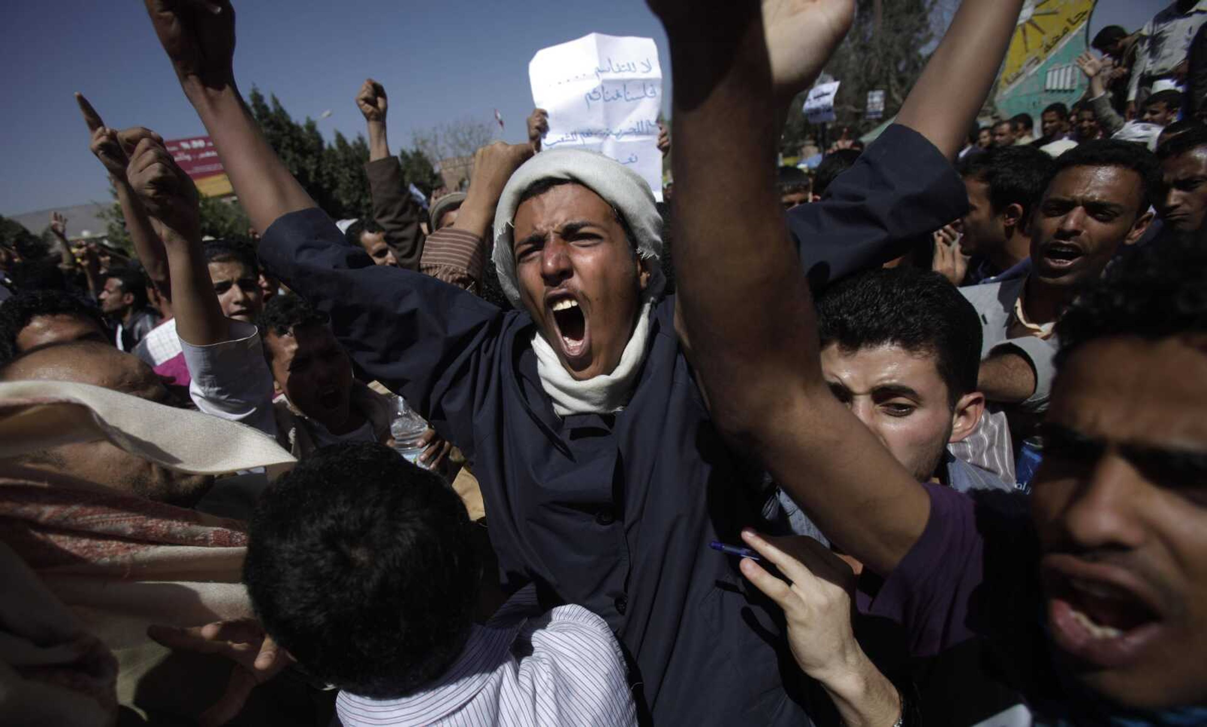 Yemeni anti-government demonstrators shout slogans during a demonstration Saturday demanding the resignation of President Ali Abdullah Saleh in Sanaa, Yemen. Hundreds of Yemenis began demonstrating early Saturday outside the university in Sanaa. "The people want the ouster of the regime," they chanted. (Muhammed Muheisen ~ Associated Press)