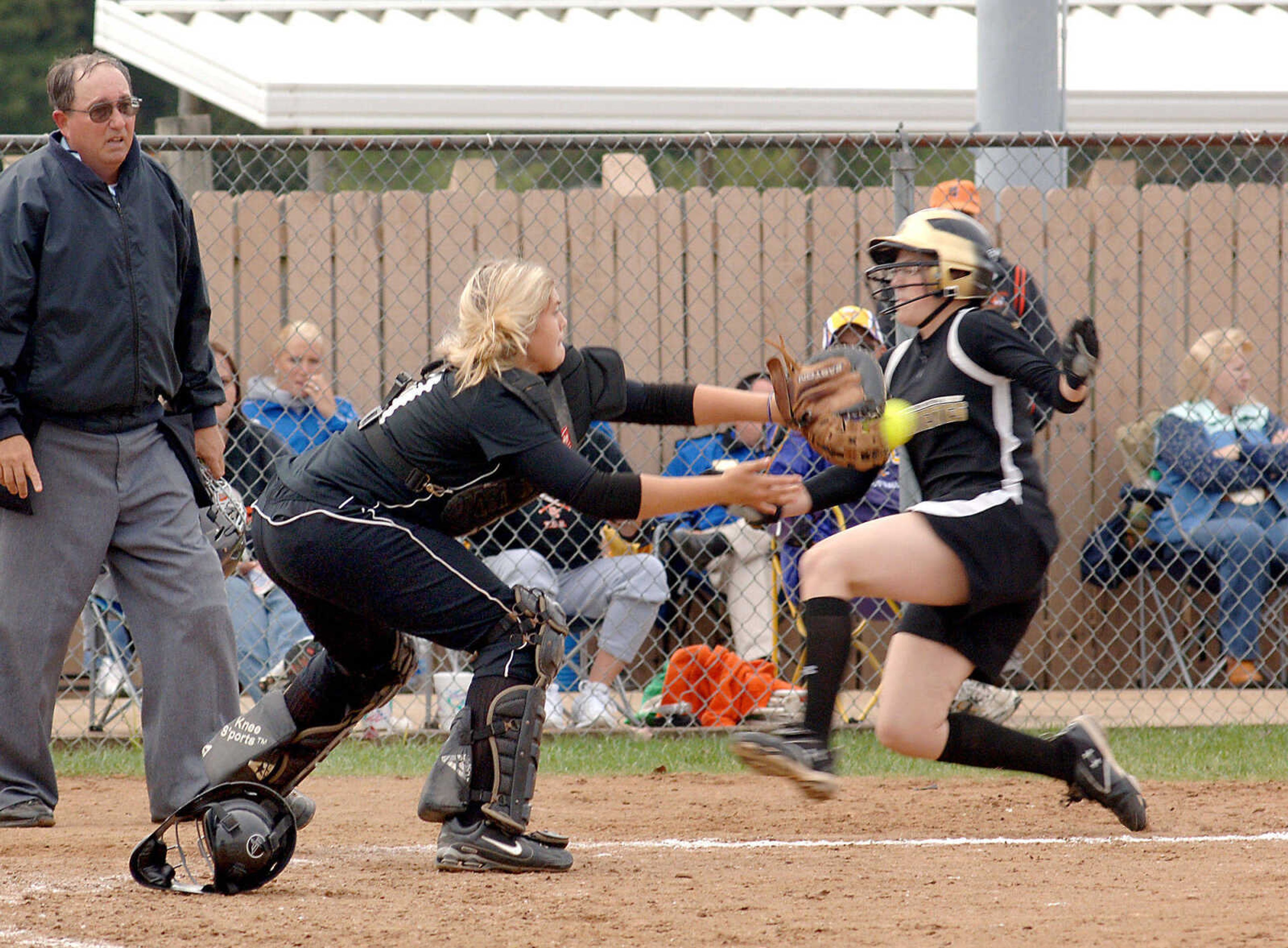 LAURA SIMON~photos@semissourian.com
The ball beat Farmington's Allie Trask, left, to home as Cape Central catcher Taylre Scott makes the out during Monday's district game in Farmington.