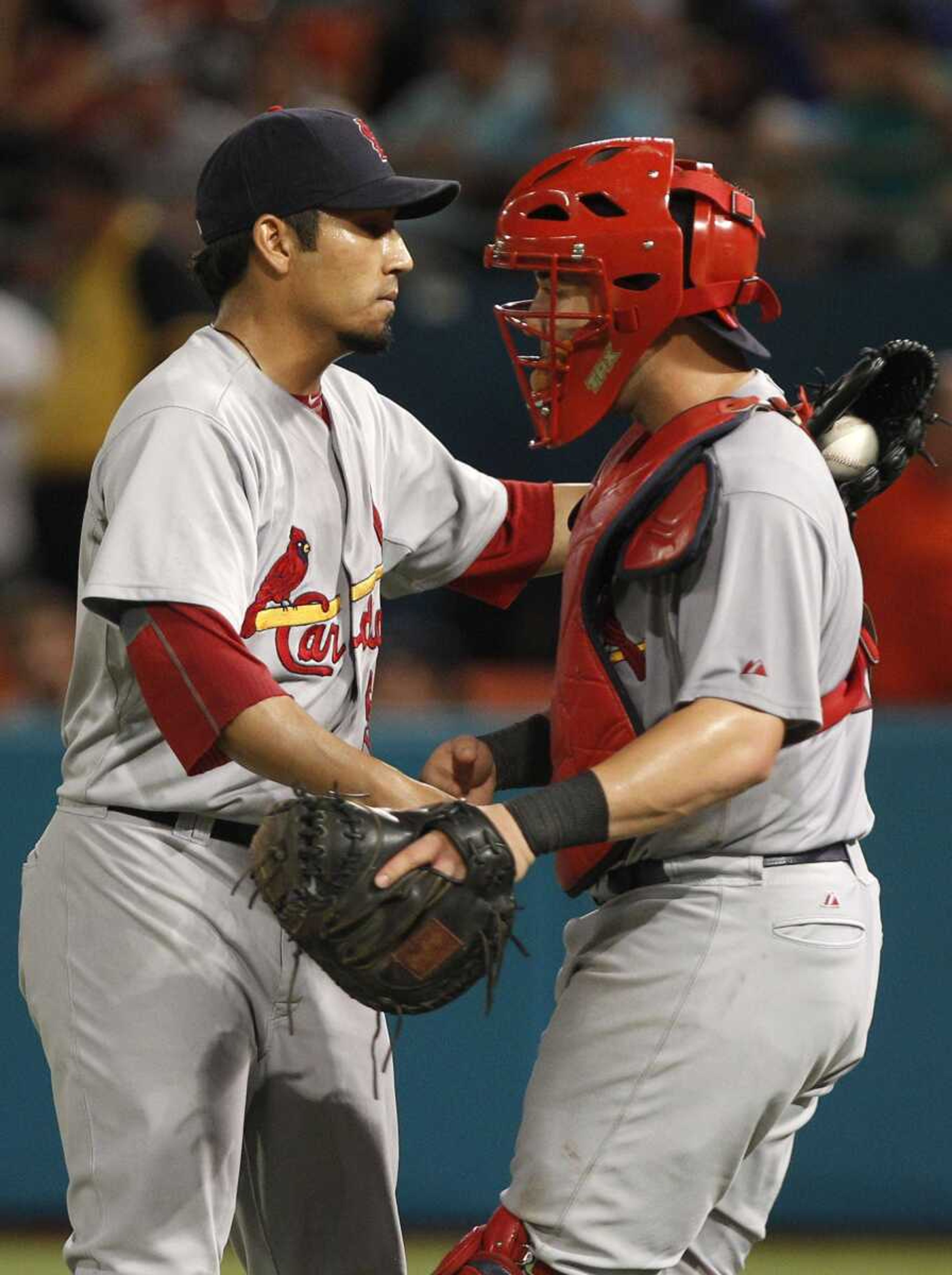 Cardinals closer Fernando Salas is congratulated by catcher Tony Cruz after the Cardinals beat the Marlins 2-1 on Saturday in Miami. (LYNNE SLADKY ~ Associated Press)