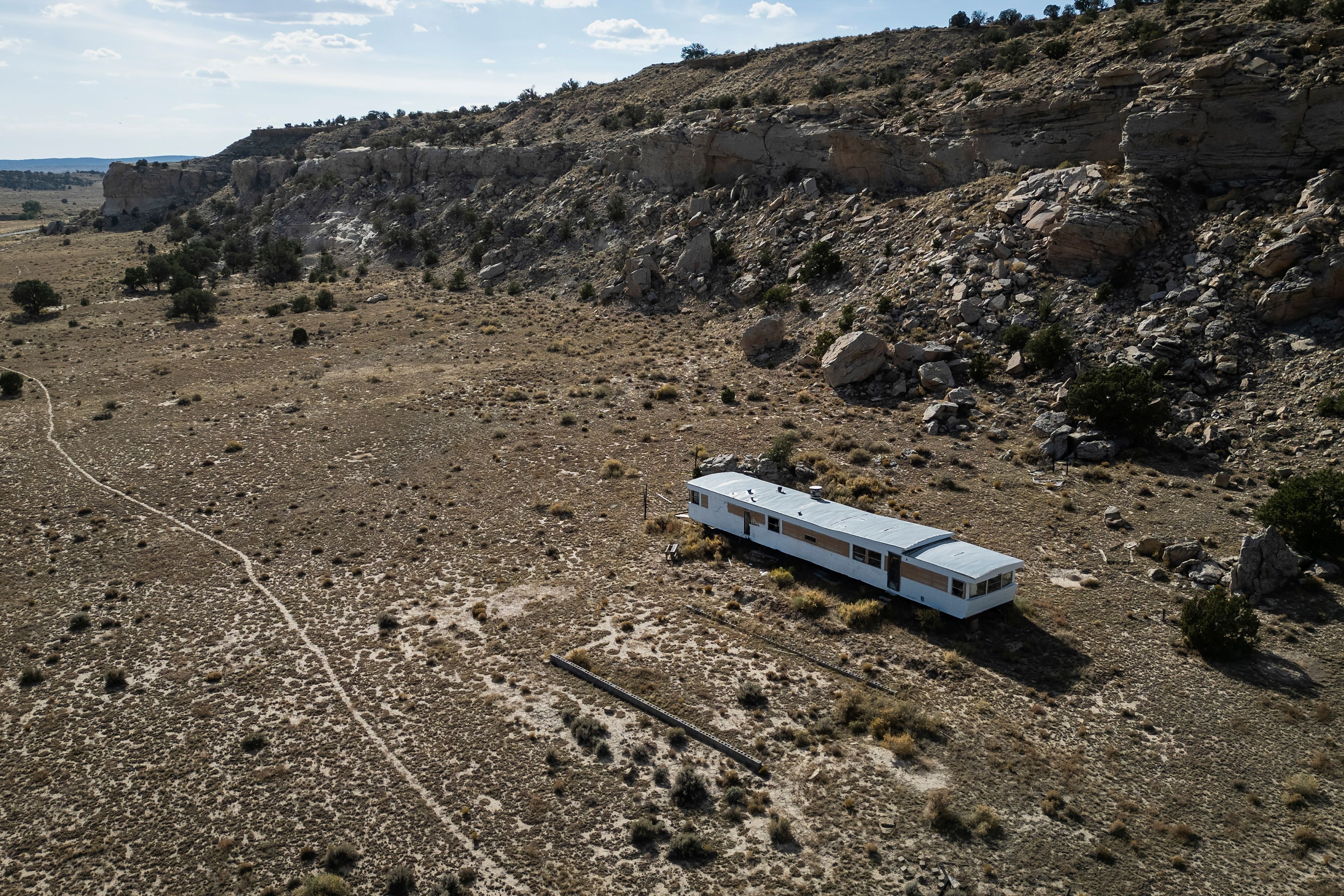 A house located next to a rocky mountain on the Navajo Nation, in Steamboat, Ariz., Friday, Oct. 11, 2024.(AP Photo/Rodrigo Abd)