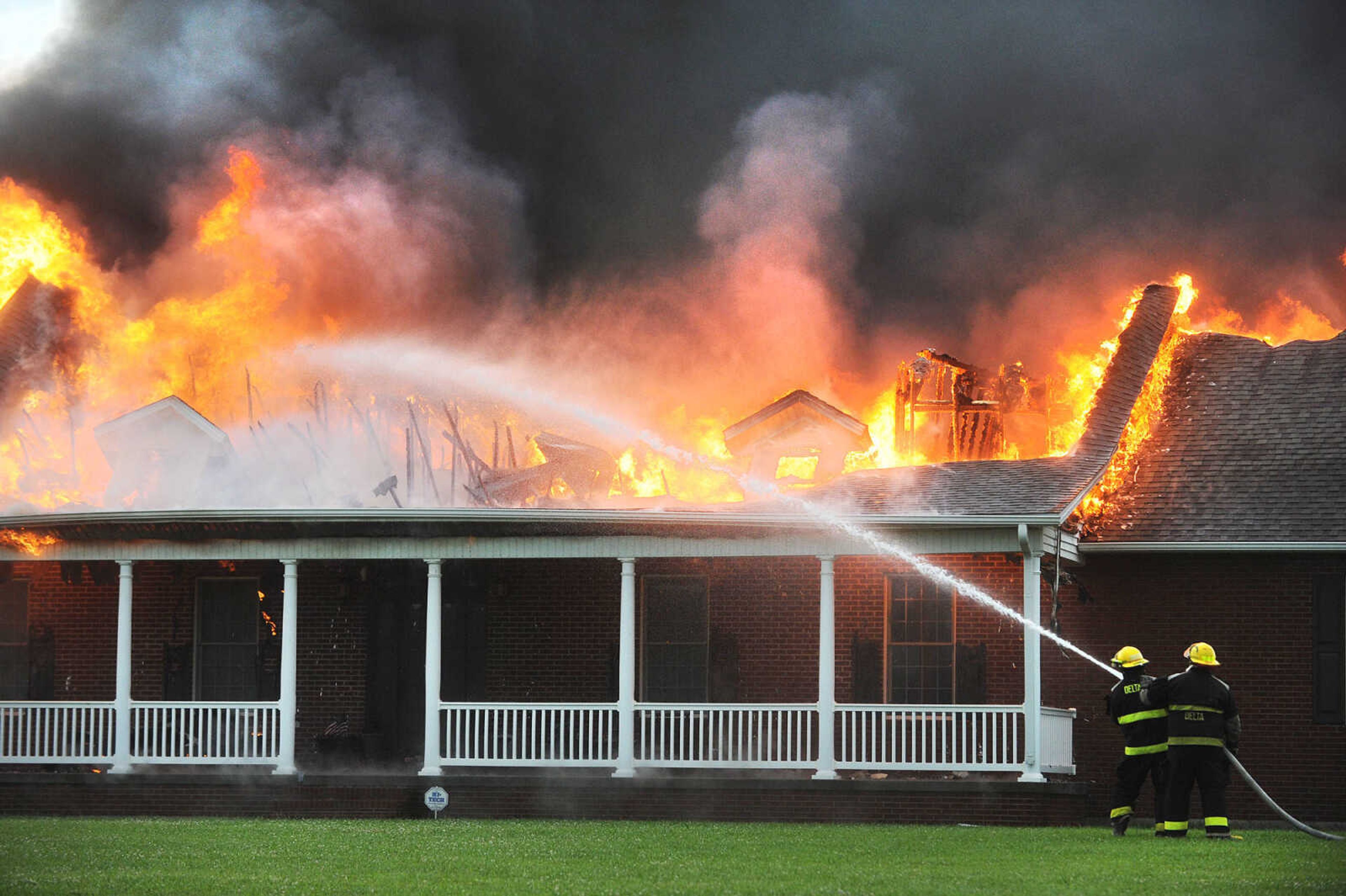 LAURA SIMON ~ lsimon@semissourian.com

Firefighters from Delta, Scott City, Chaffee and New Hamburg/Benton/Commerce battle a house fire off County Road 204 in Scott County Wednesday afternoon, July 23, 2014.