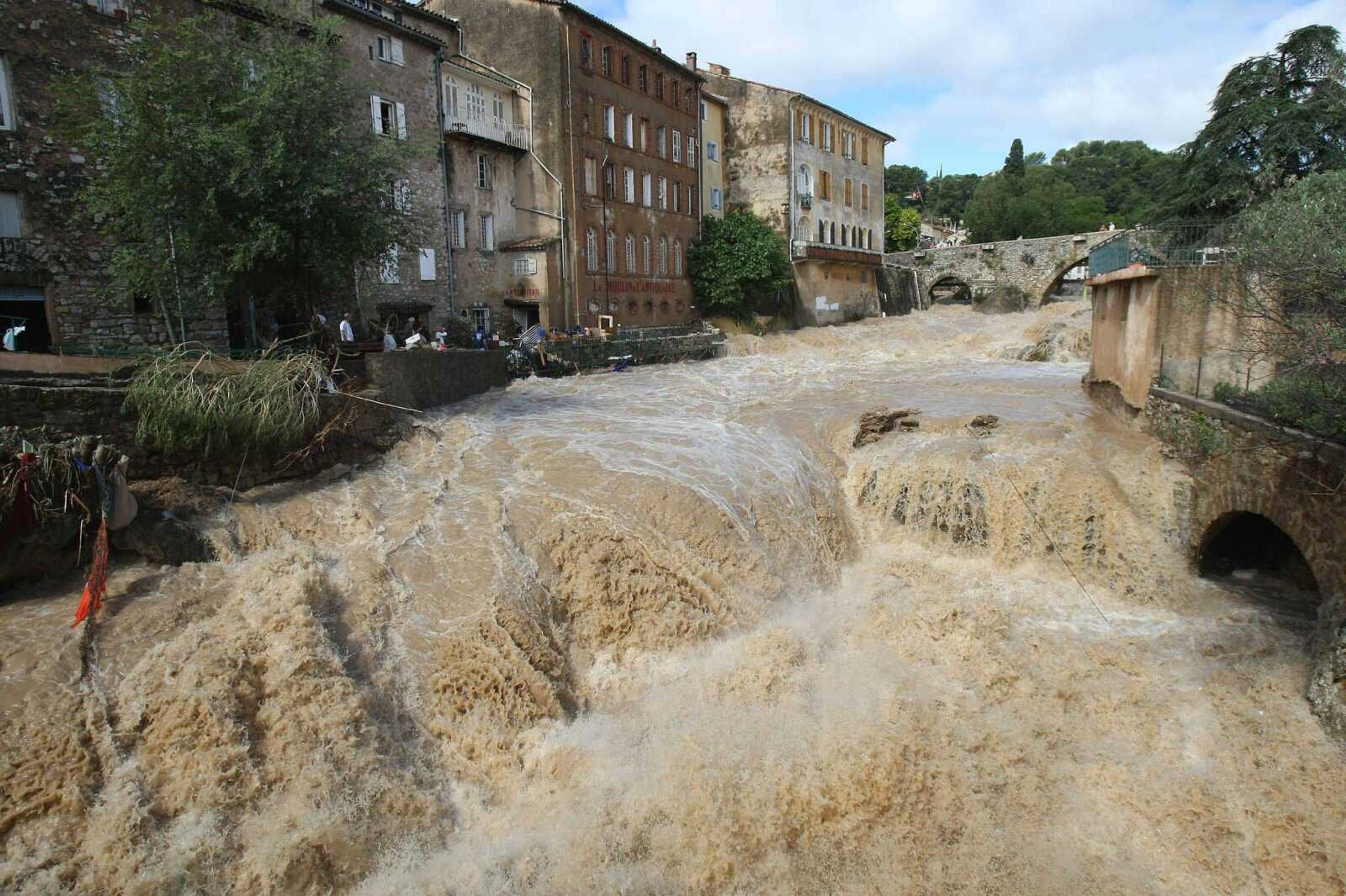 The river Artuby floods Draguignan, southern France, on Wednesday. Regional authorities in southeastern France say at least a dozen people have been killed and many are missing in the aftermath of flash floods that followed powerful rainstorms. (LIONEL CIRONNEAU ~ Associated Press)