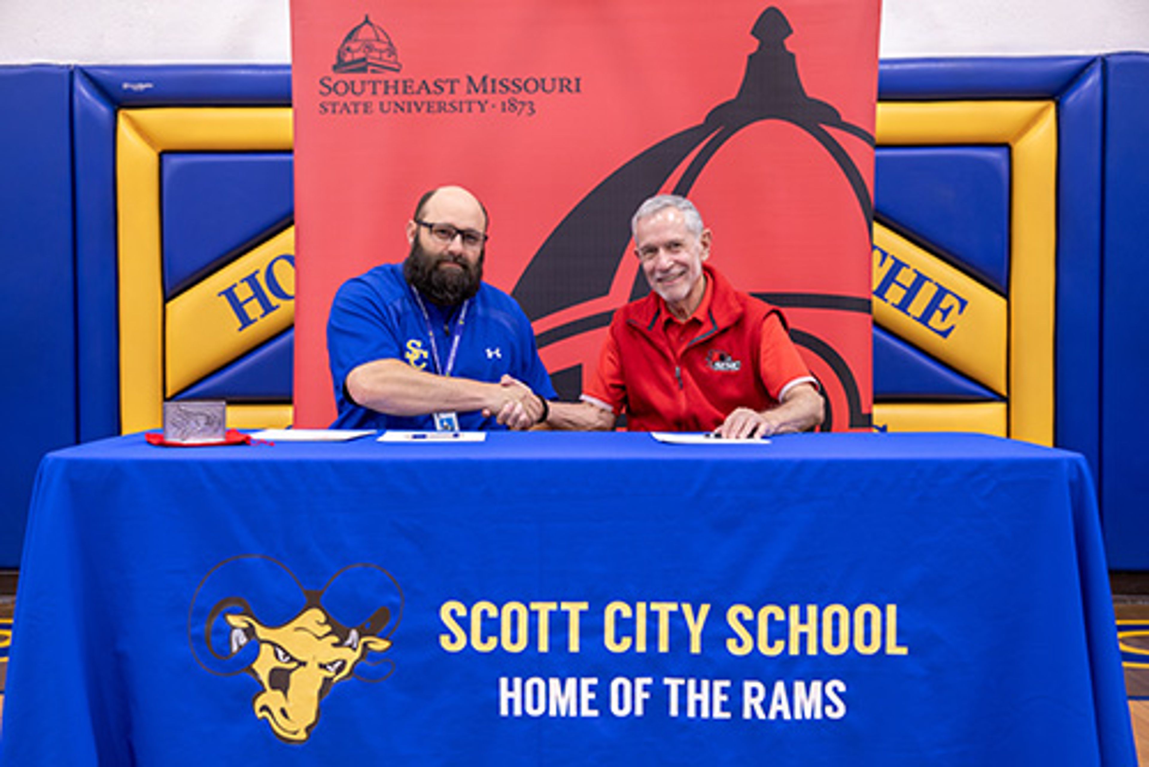 Scott City R-I Public Schools superintendent Lance Amick, left, shakes hands with Southeast Missouri State University president Carlos Vargas after signing a partnership agreement to join SEMO’s Educators Advantage program.