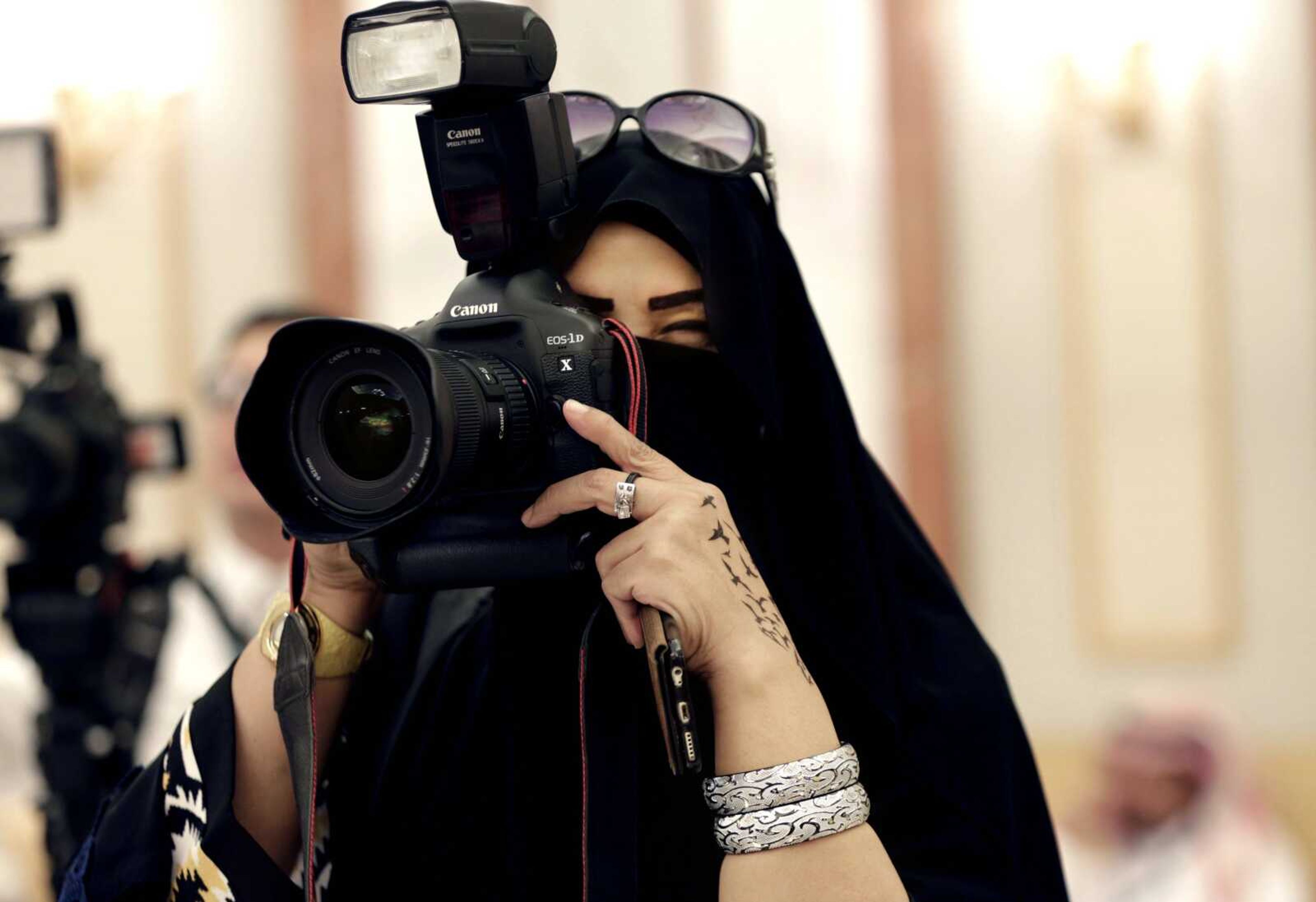 A journalist takes photos Nov. 10 at a palace in Riyadh, Saudi Arabia. In Riyadh, Jowhara al-Wably is making history by running as a female candidate in upcoming elections. (Hasan Jamali ~ Associated Press)