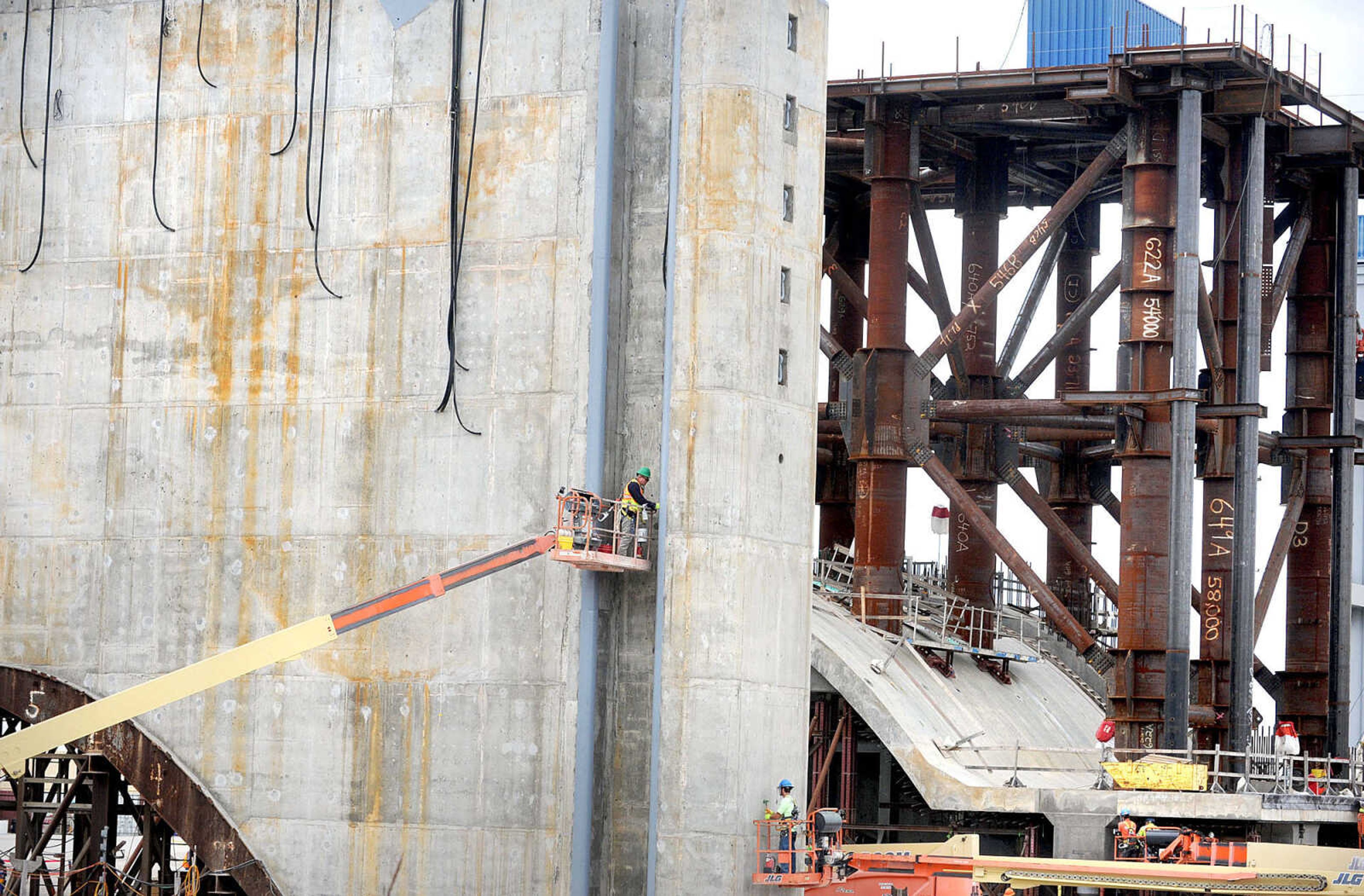 LAURA SIMON ~ lsimon@semissourian.com

A construction worker works in the downstream bulkhead recess of lower pier shell number five in the casting yard of Olmsted Locks and Dam, Tuesday, Nov. 5, 2013, in Olmsted, Ill. The lower pier shell number five will become part of the tainter gate section of the dam on the Ohio River. A tainter gate controls water flow. In the background is sill shell six with it's lifting frame attached.