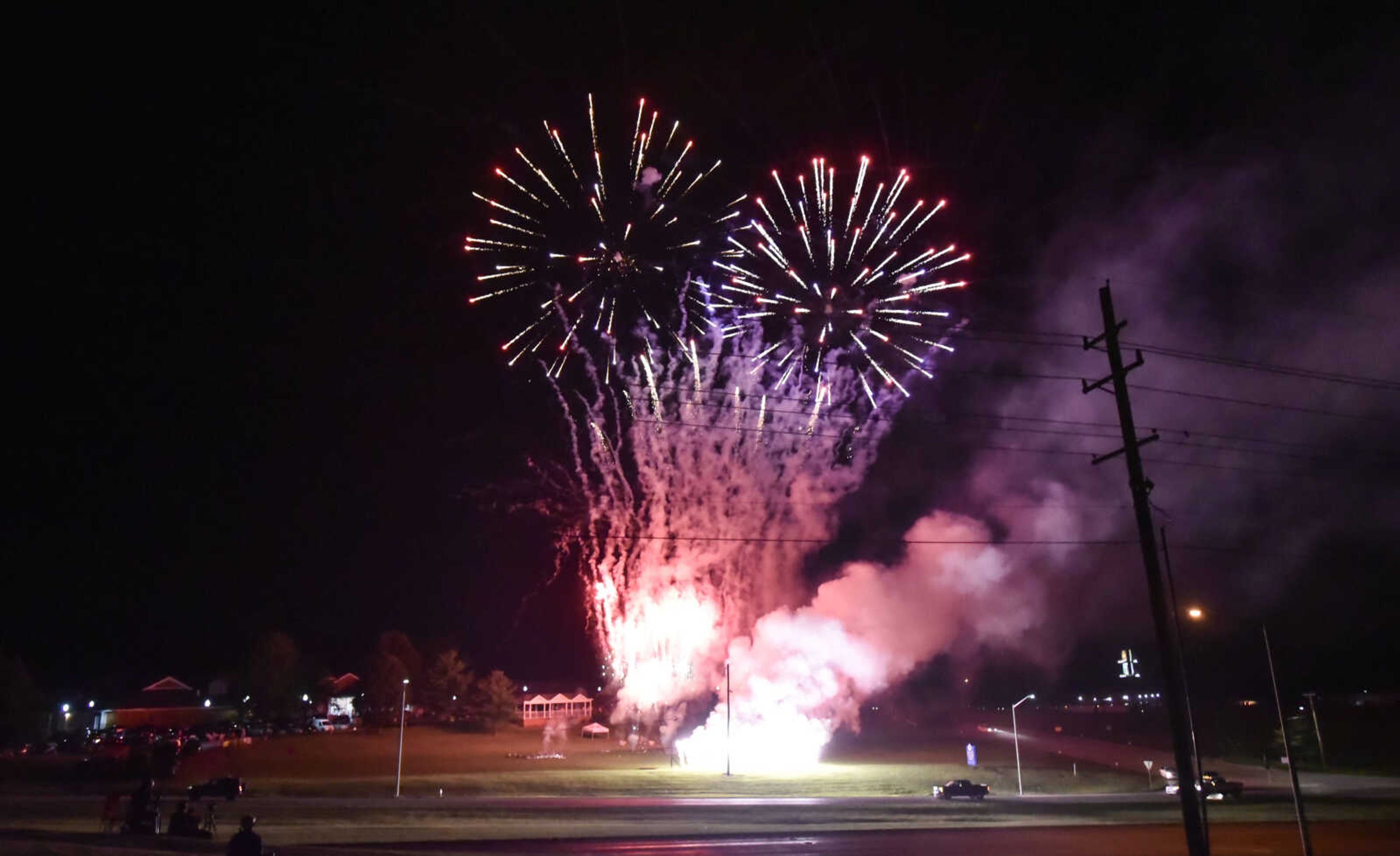 Fireworks burst in the sky as waterfalls light up the Missouri Veterans Home lawn during the grand finale of the firework show Tuesday, July 3, 2018, in Cape Girardeau.