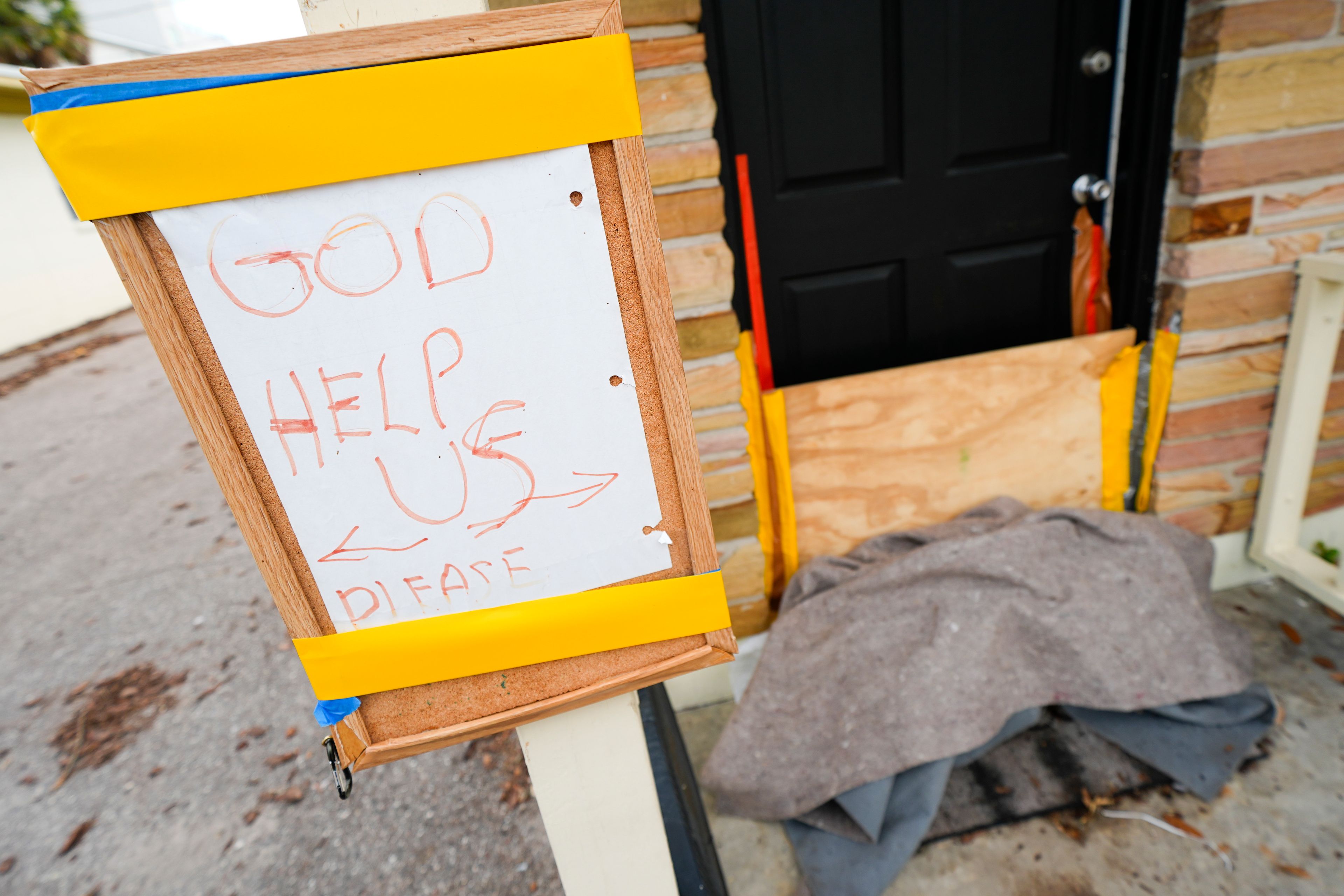 A message is seen outside of an apartment in the Davis Islands community of Tampa, Fla., as residents prepare for the arrival of Hurricane Milton, Tuesday, Oct. 8, 2024. (AP Photo/Julio Cortez)