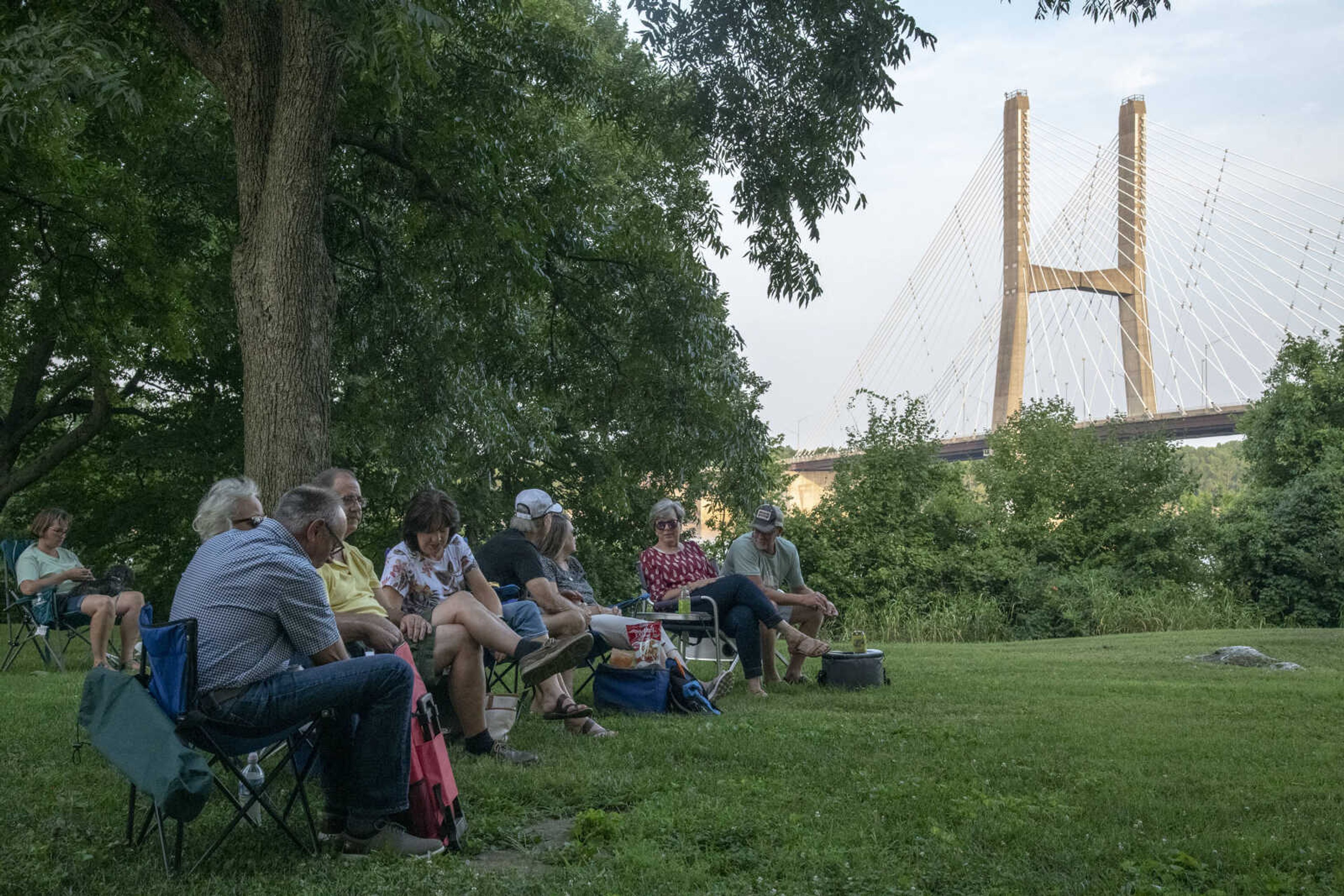 The audience chats and listens as Anne McCue performs during Tunes at Twilight at the River Campus Friday Aug. 6, 2021.