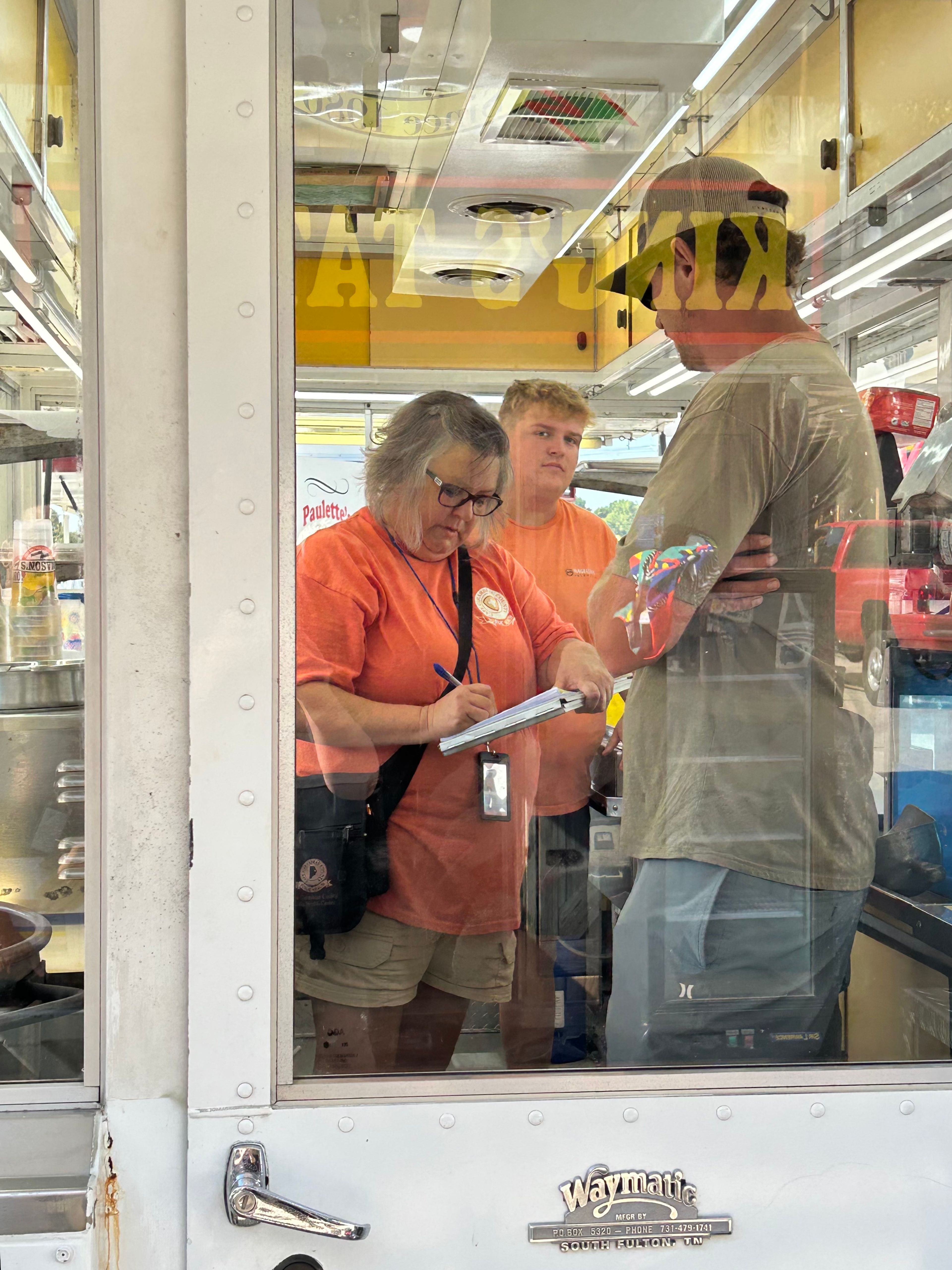 Amy Morris, an environmental public health supervisor with the Cape Girardeau County Public Health Center, talks to Mason Miller and Xavier Trammel of Mason Miller Food Service as she performs an inspection at the SEMO District Fair on Friday morning, Sept. 6, at Arena Park in Cape Girardeau.