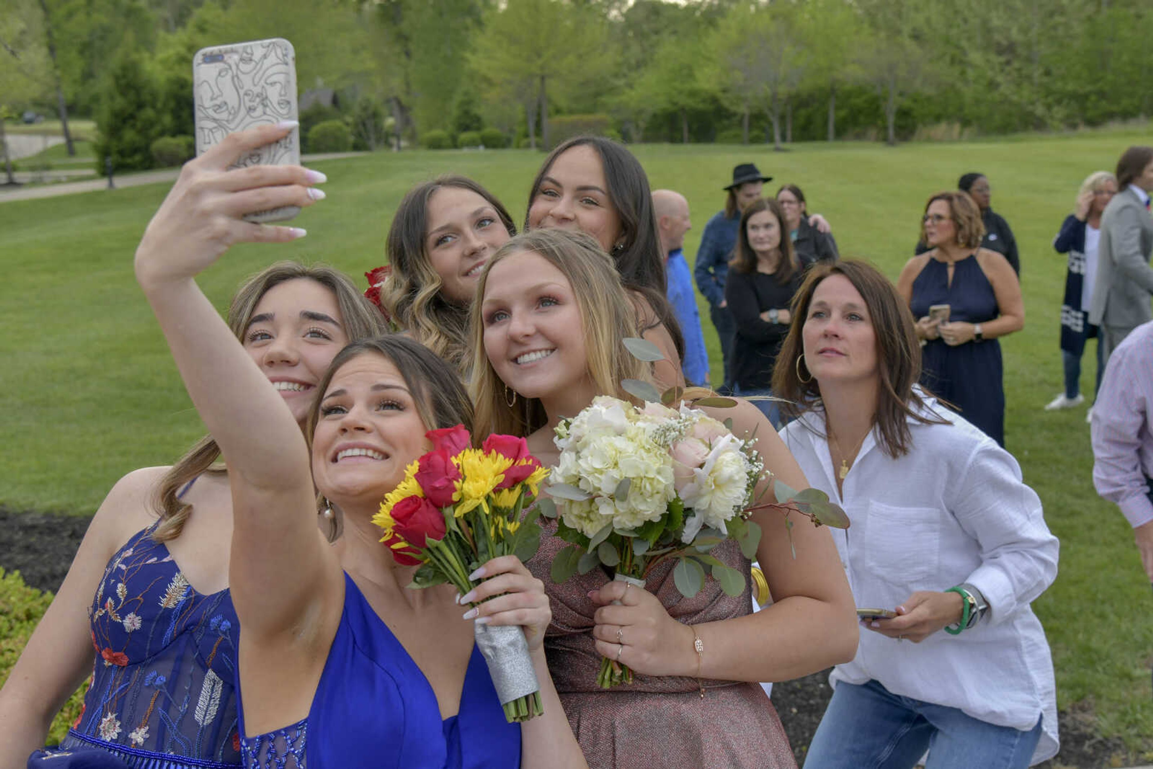 Paige Elder, front, takes a selfie on her phone with other students during a pre-prom event at the Dalhousie Golf Club in Cape Girardeau on Saturday, May 8, 2021.