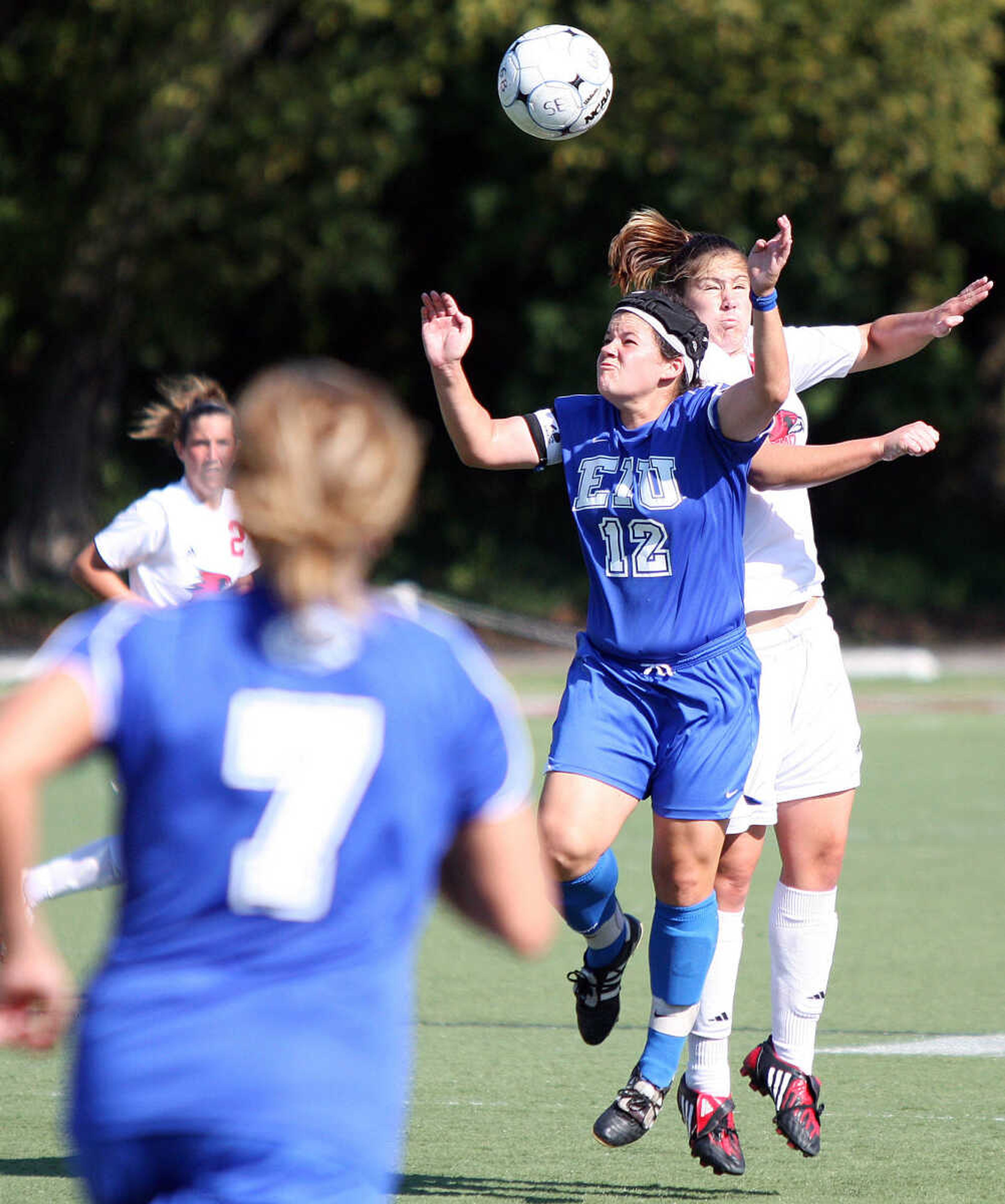 Hayley Abbott, right, leaps over Alexis Miller, center, for the ball during the soccer game Sunday afternoon.