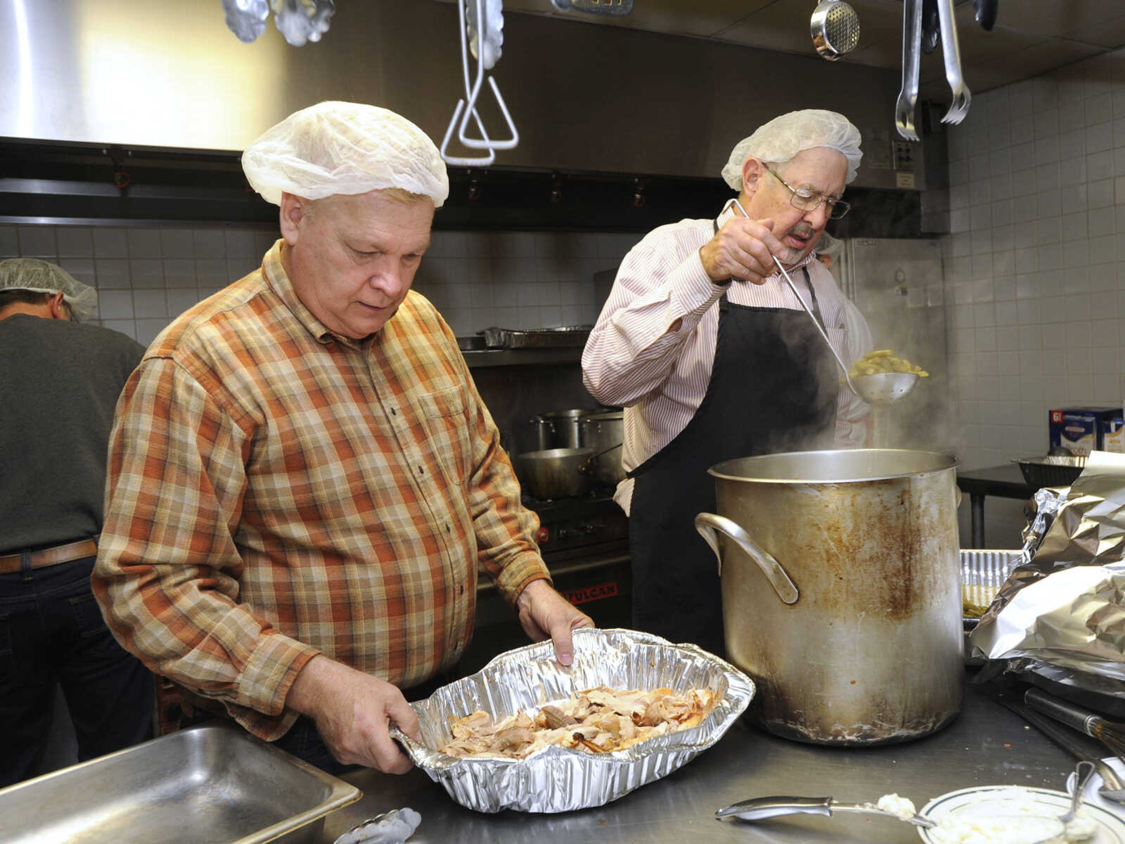 FRED LYNCH ~ flynch@semissourian.com
Brent Wills, left, and Bill Hinckley work in the kitchen Thursday, Nov. 23, 2017 to prepare for the Thanksgiving Day luncheon at the Salvation Army in Cape Girardeau.