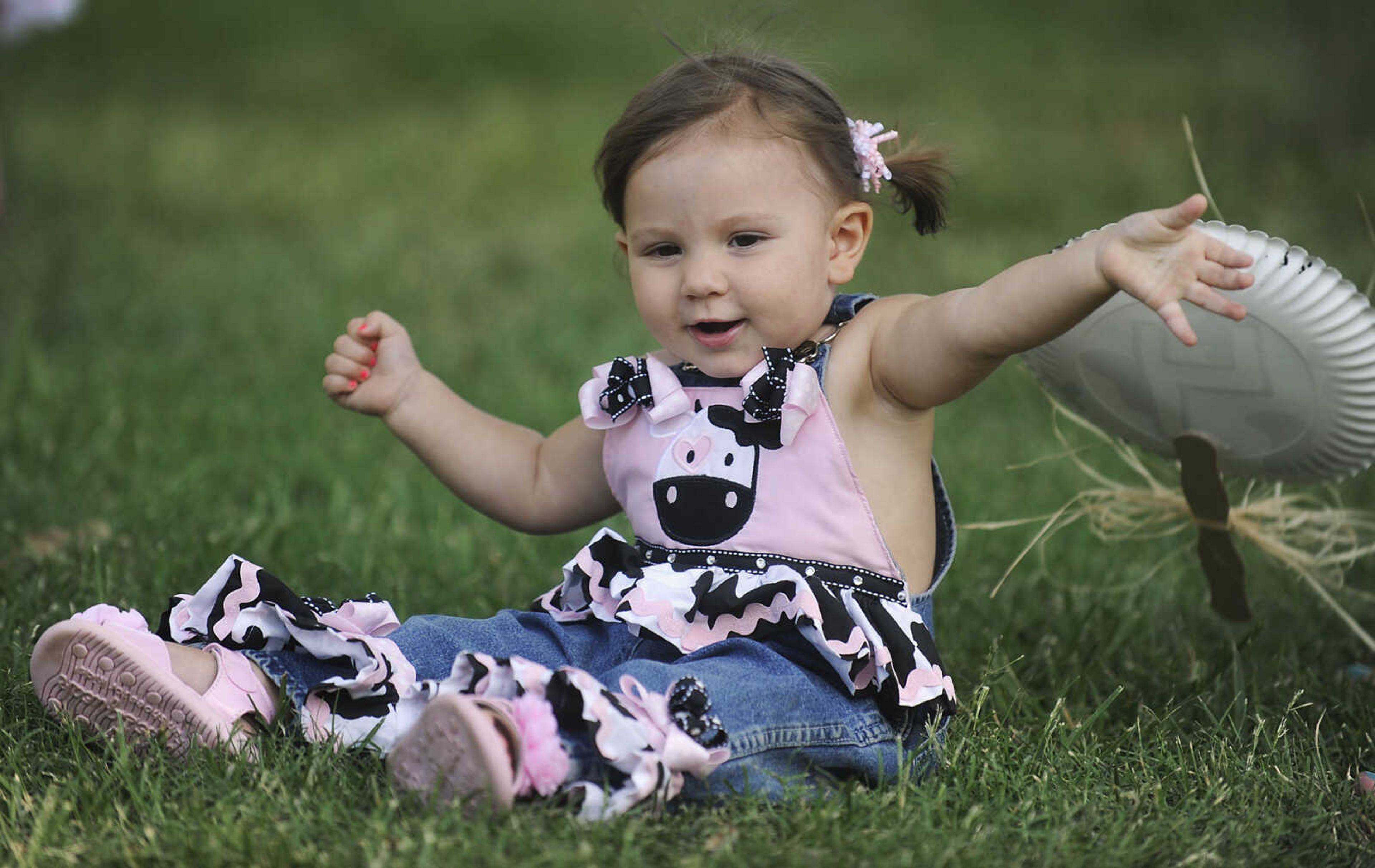 Fourteen month-old Liza Dohogne plays in the grass
during Chaffee's Annual German Days Festival Friday, August 10, at Frisco Park.