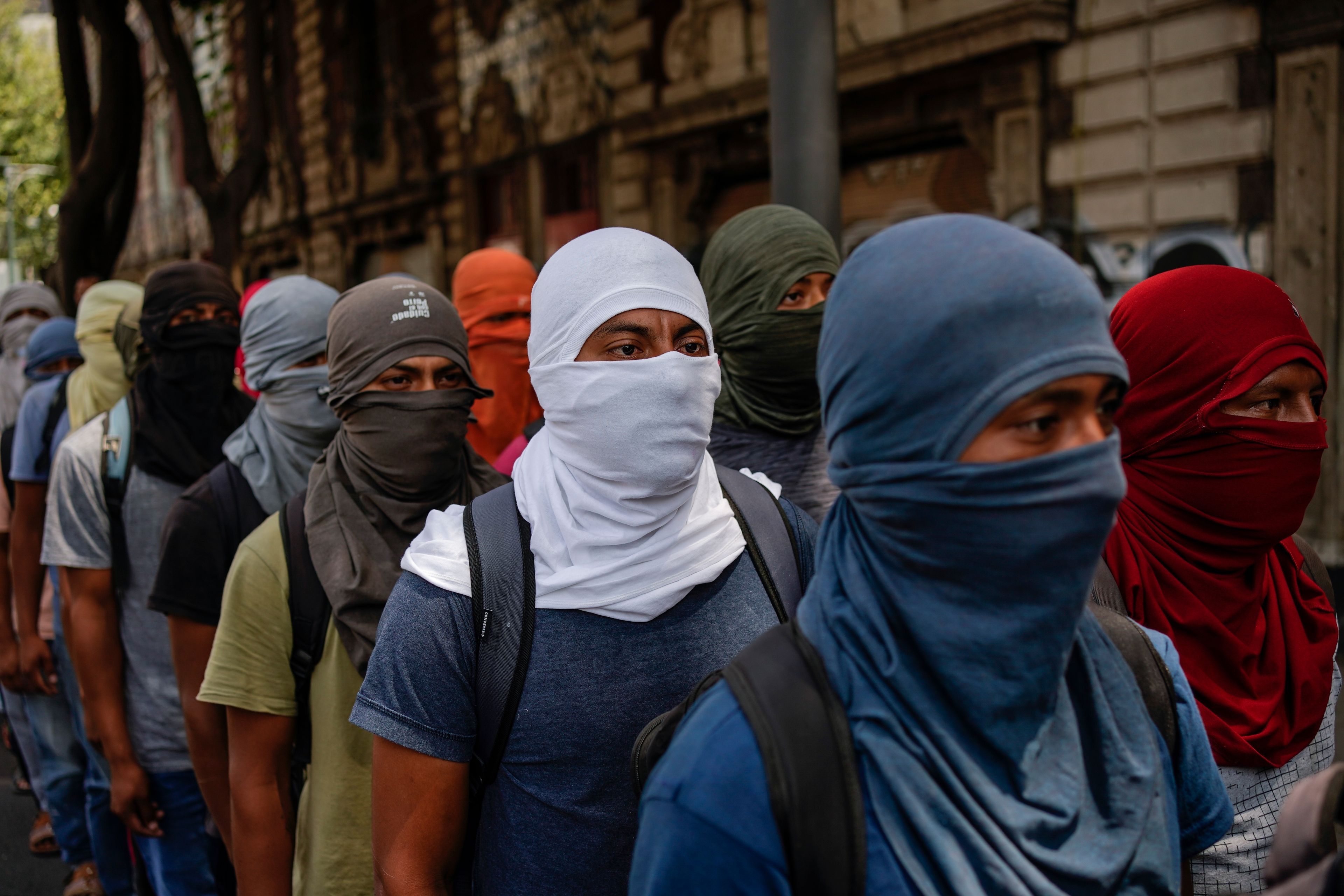 Hooded students demonstrate ahead of the 10th anniversary of the disappearance of 43 Ayotzinapa students in Guerrero state, outside the Interior Ministry in Mexico City, Monday, Sept. 23, 2024. (AP Photo/Felix Marquez)