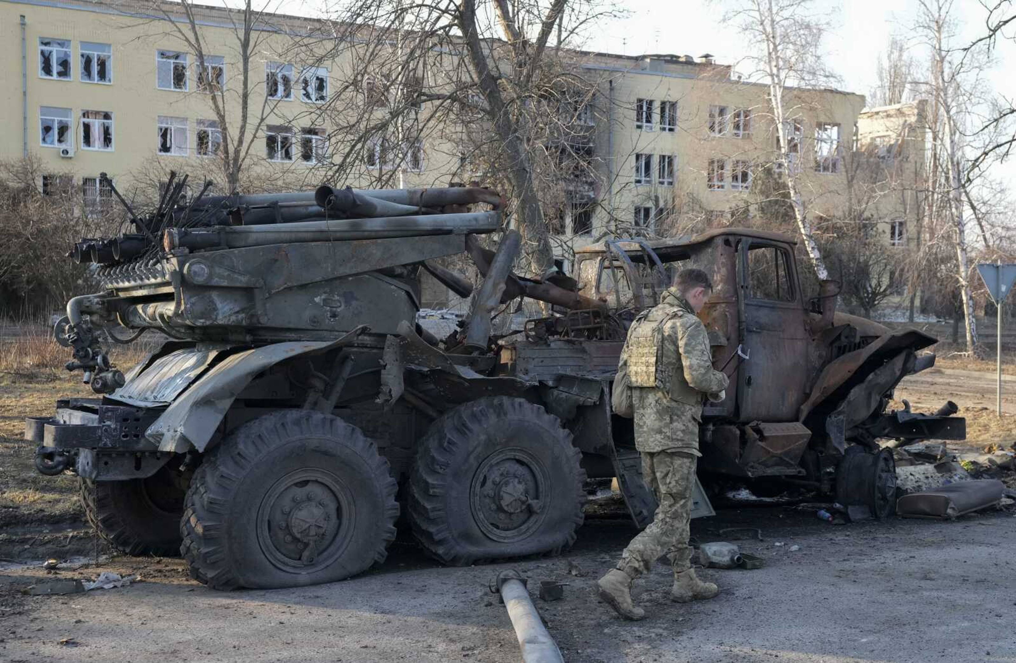 A Ukrainian soldier passes by a destroyed Russian artillery system 'Grad' on Thursday  in Kharkiv, Ukraine.