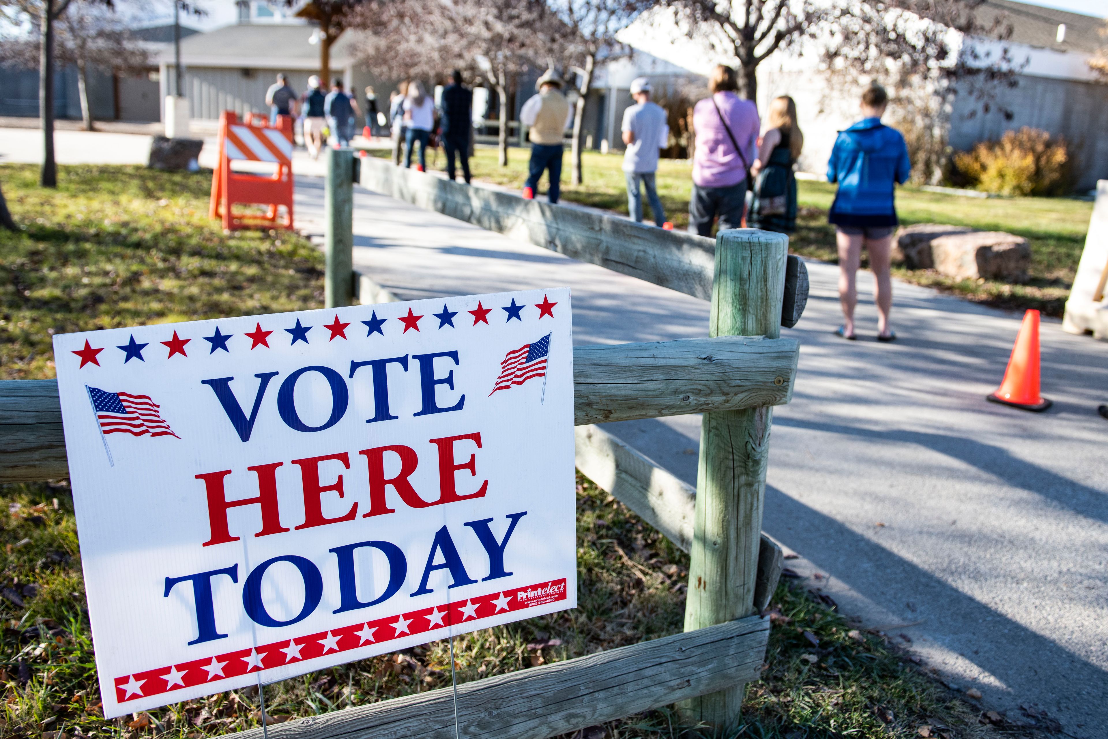 FILE - Patrons of the Gallatin County Fairgrounds wait in line to cast their ballots in Bozeman, Mont., Nov. 3, 2020. (AP Photo/Tommy Martino, File)