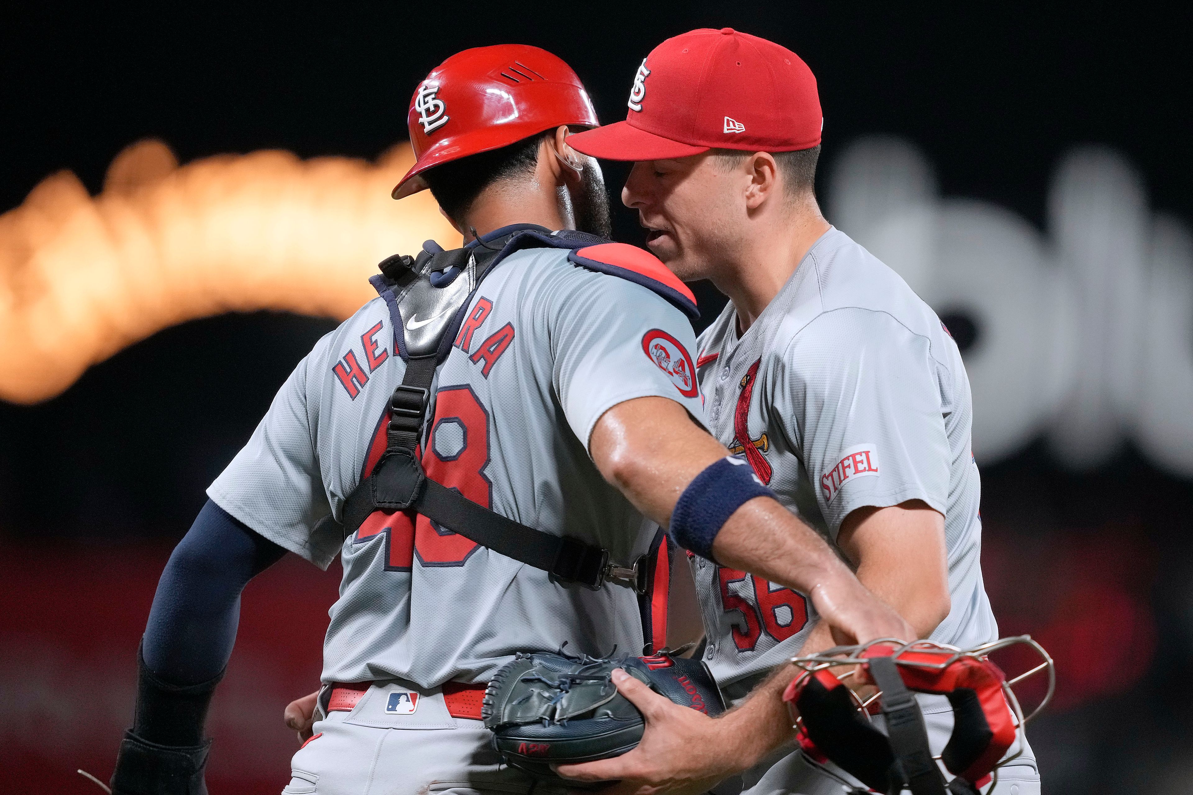 St. Louis Cardinals pitcher Ryan Helsley, right, hugs catcher Iván Herrera (48) after a victory against the San Francisco Giants in a baseball game Friday, Sept. 27, 2024, in San Francisco. (AP Photo/Tony Avelar)