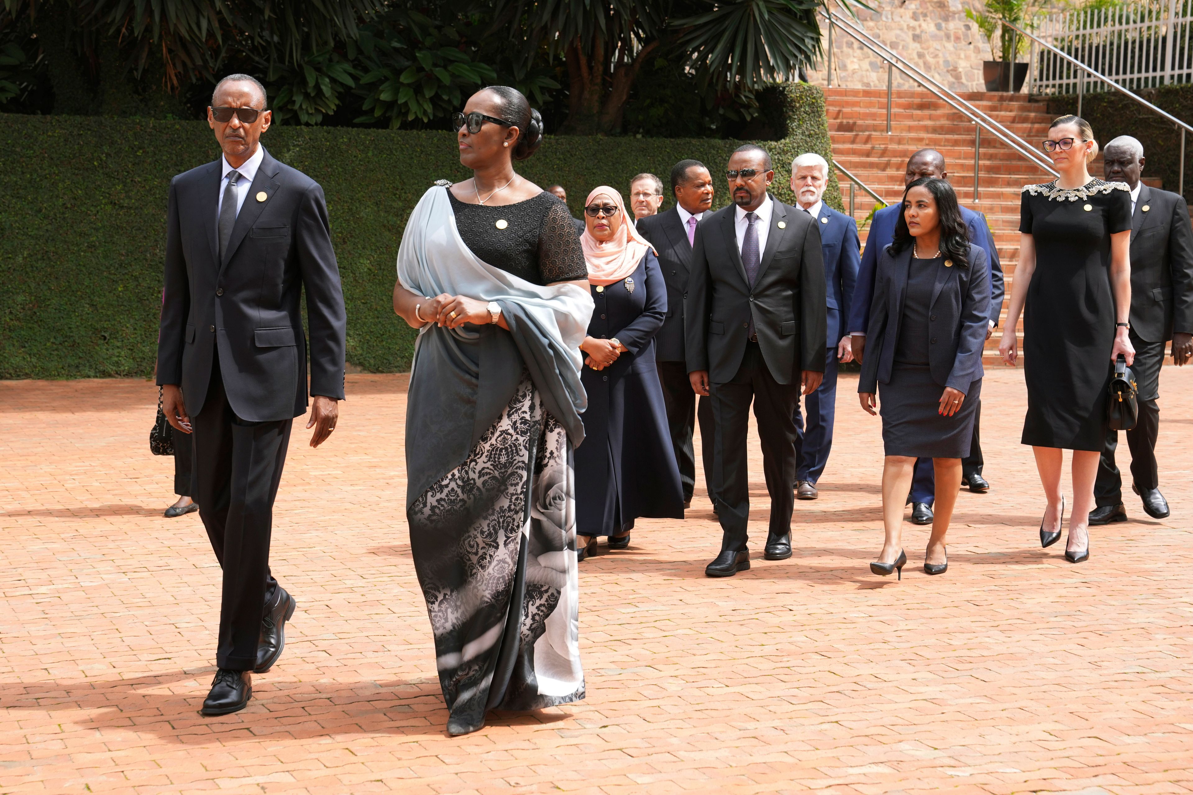 FILE -Rwandan President Paul Kagame, left, and his wife, first lady Jeannette Kagame lead other dignitaries as they arrive for a ceremony to mark the 30th anniversary of the Rwandan genocide, held at the Kigali Genocide Memorial, in Kigali, Rwanda, April 7, 2024. (AP Photo/Brian Inganga, File)