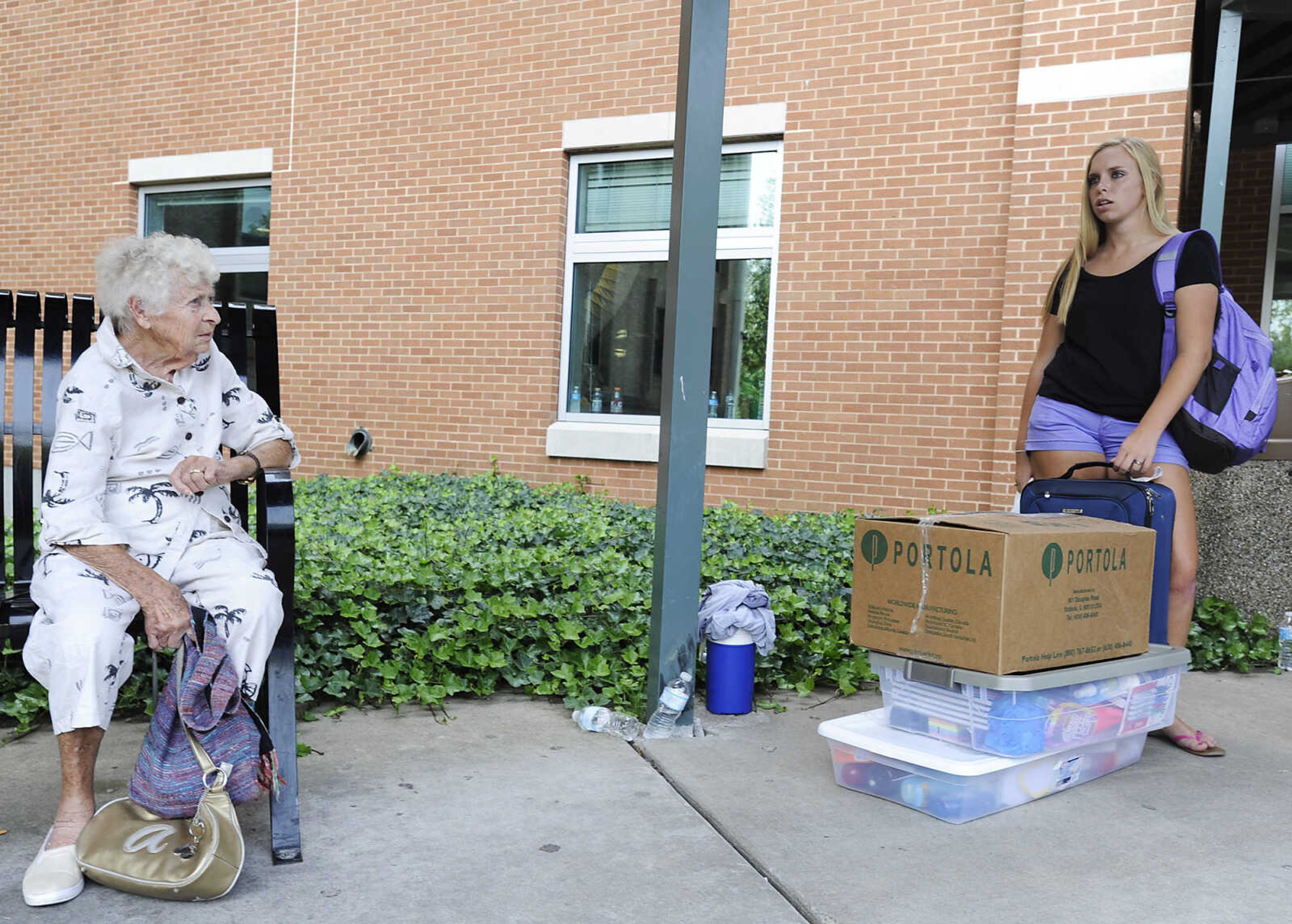 Catie Delaney, right and her grandmother, Anne Delany wait with Katie's belongings as she moves into the Towers East residence hall during move in day Thursday, Aug. 22, at Southeast Missouri State University. Several campus organizations provided volunteers to help the approximately 1,100 students who moved into on-campus housing between 6 a.m and 1 p.m.