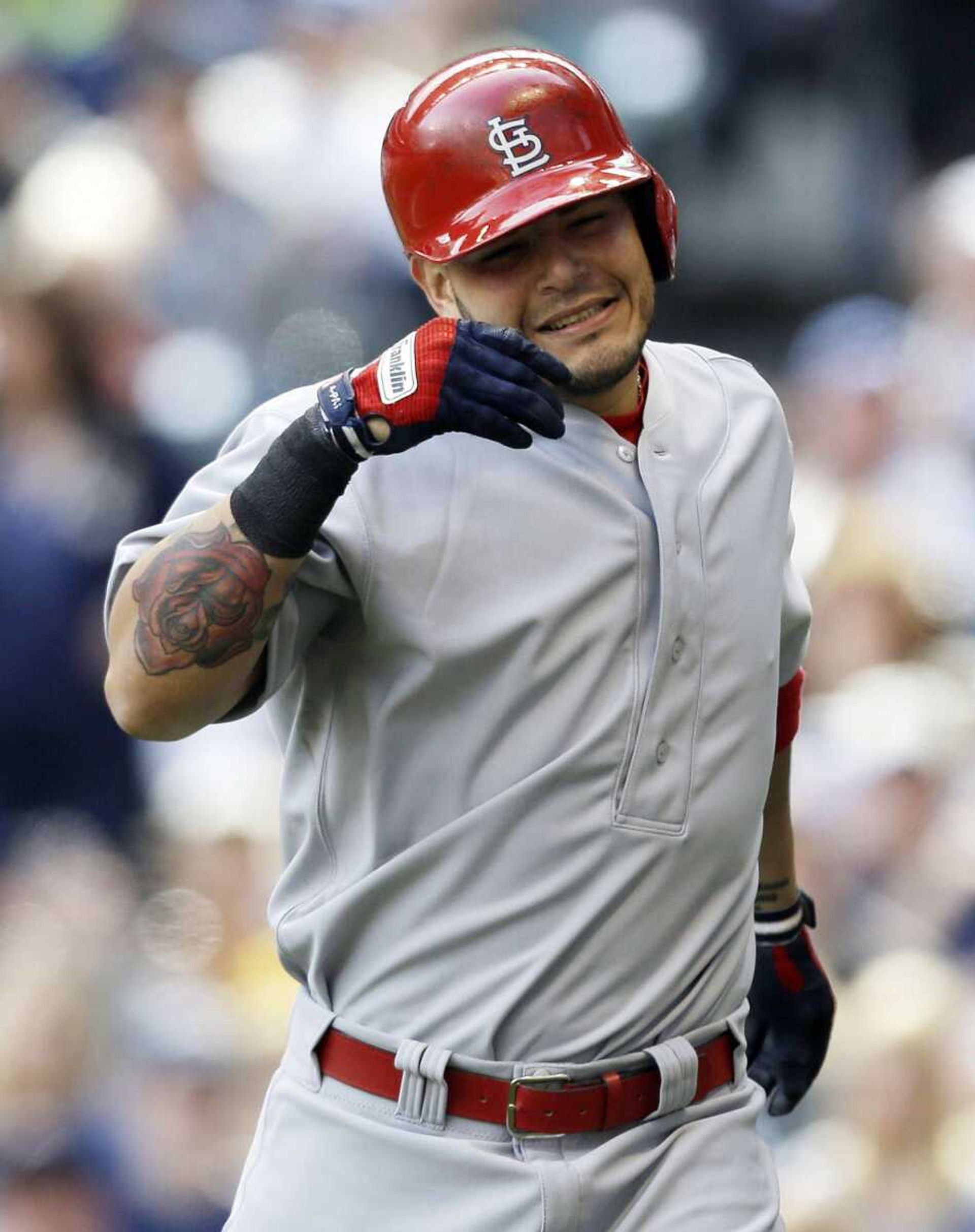 St. Louis Cardinals' Yadier Molina reacts after getting hit with a ball by Milwaukee Brewers during the sixth inning of a baseball game on Sunday, May 5, 2013, in Milwaukee. (AP Photo/Jeffrey Phelps)