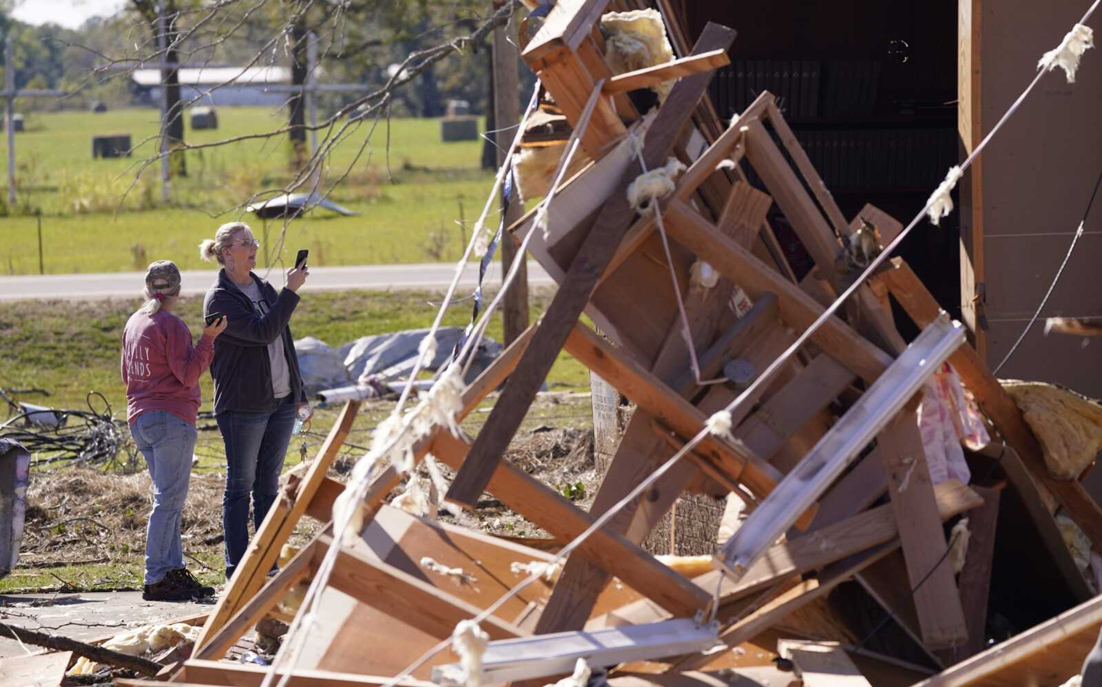 Women look at the Trinity Baptist Church that was destroyed by a tornado Saturday, Nov. 5, in Idabel, Oklahoma.