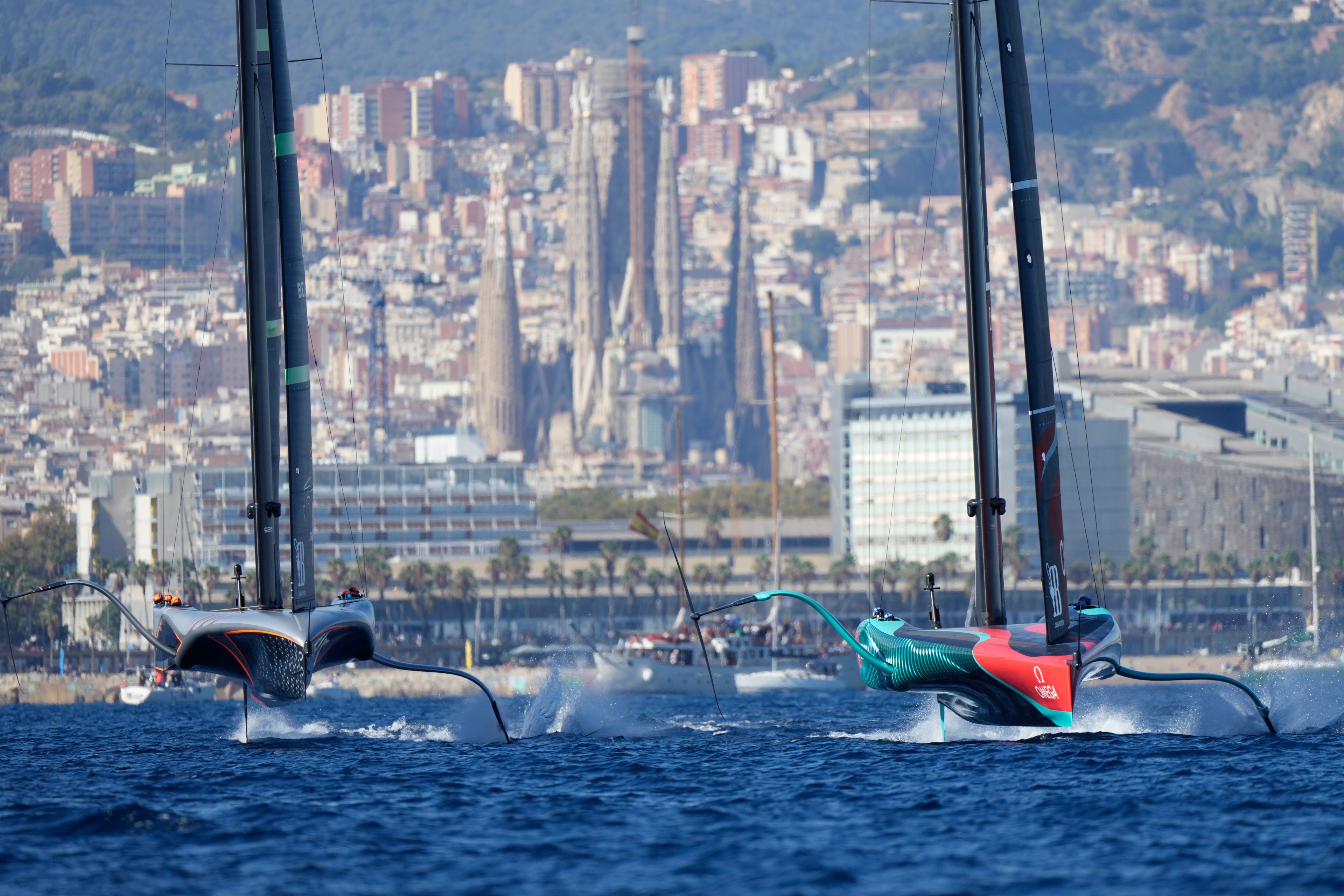 Emirates Team New Zealand, right, and Ineos Brittania race during the Louis Vuitton 37th America's Cup Day 6 race 9 in Barcelona, Spain, Saturday, Oct.19, 2024. (AP Photo/Bernat Armangue)