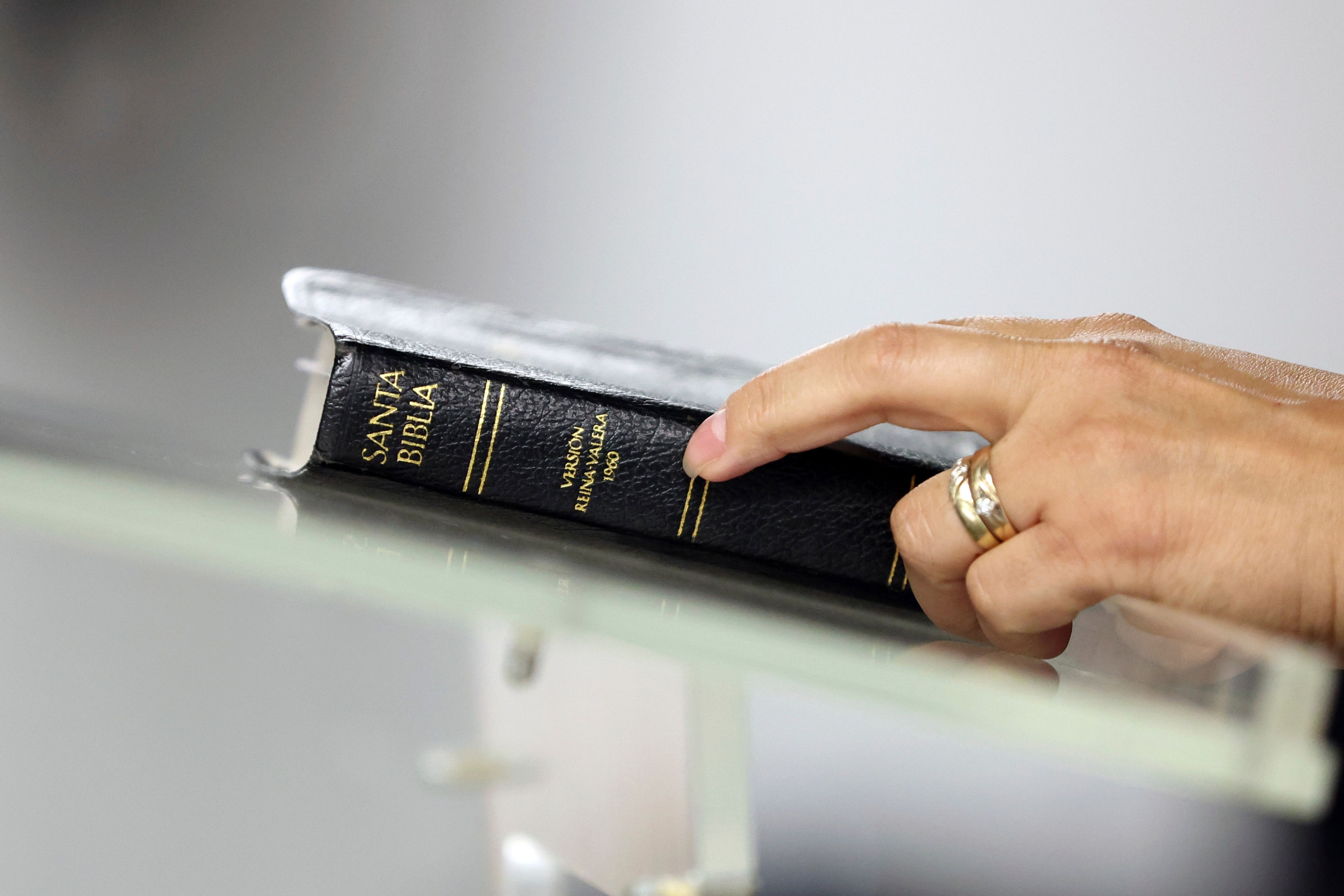 A worshipper holds a bible during services at Casa de Adoracion, Sunday, Oct. 27, 2024 in Phoenix. (AP Photo/Chris Coduto)