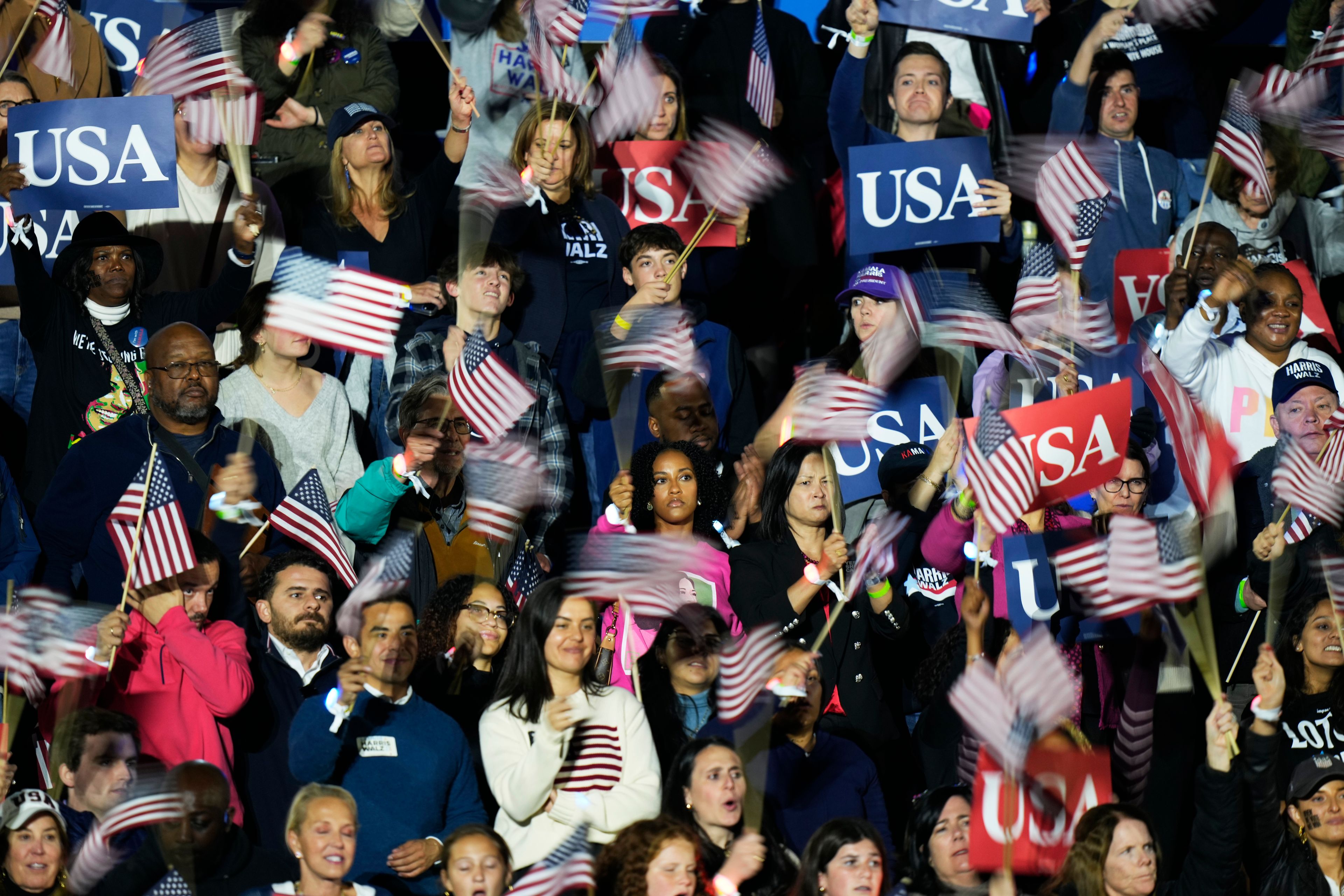 Supporters wave flags as Democratic presidential nominee Vice President Kamala Harris delivers remarks during a campaign event at the Ellipse near the White House in Washington, Tuesday, Oct. 29, 2024. (AP Photo/Stephanie Scarbrough)