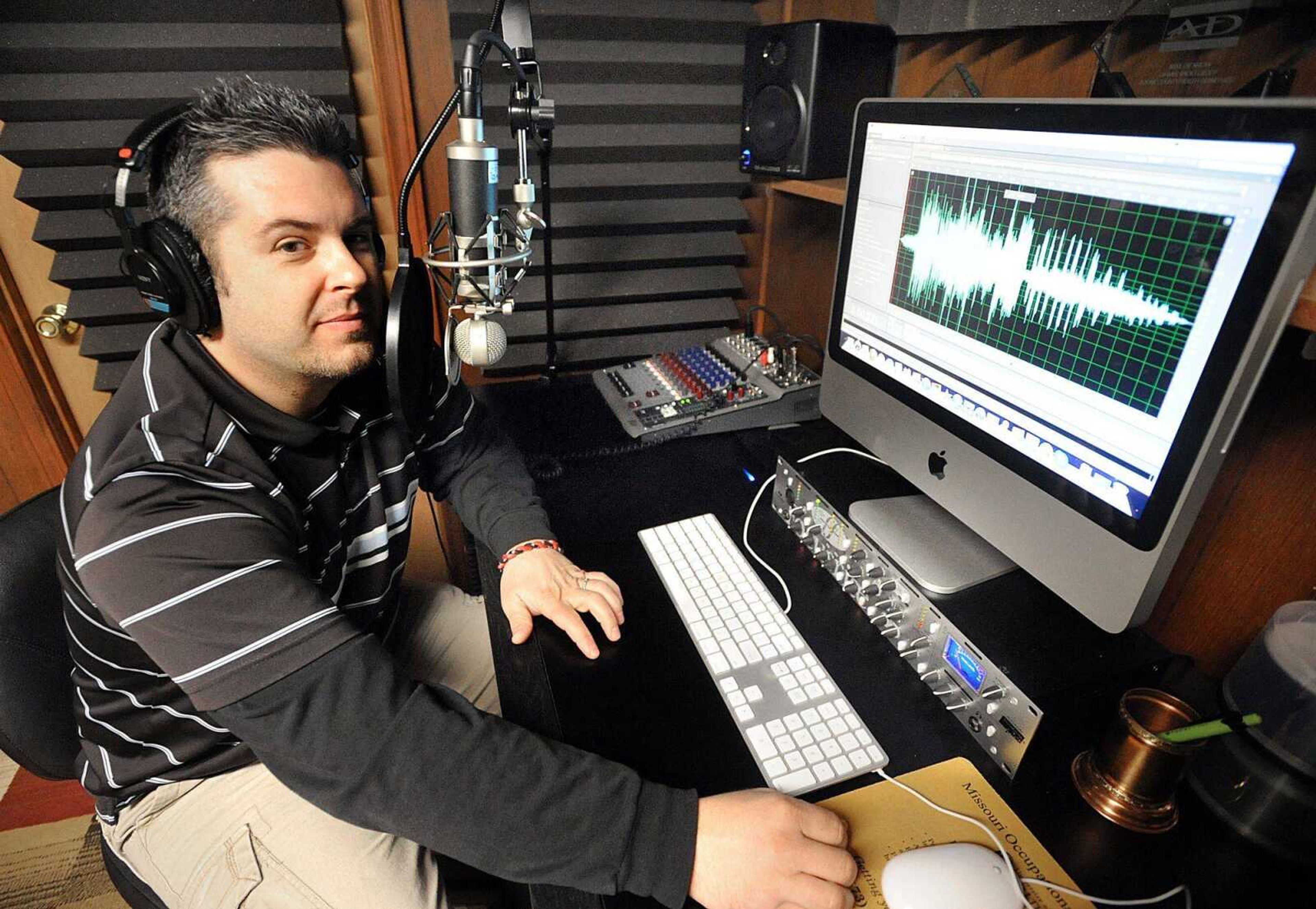 Jeff Augustine sits Friday in his Cape Girardeau home studio on where he records his voice-over work. (Laura Simon)