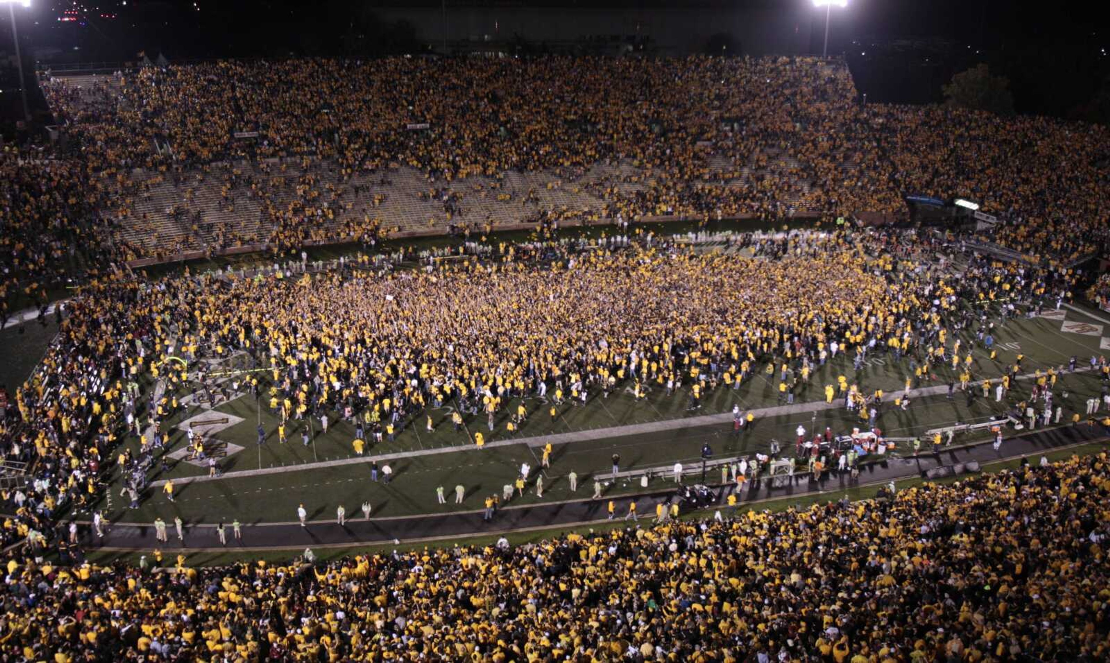 Fans storm the field following Missouri's 36-27 victory over Oklahoma in an NCAA college football game Saturday, Oct. 23, 2010, in Columbia, Mo. (AP Photo/Jeff Roberson)