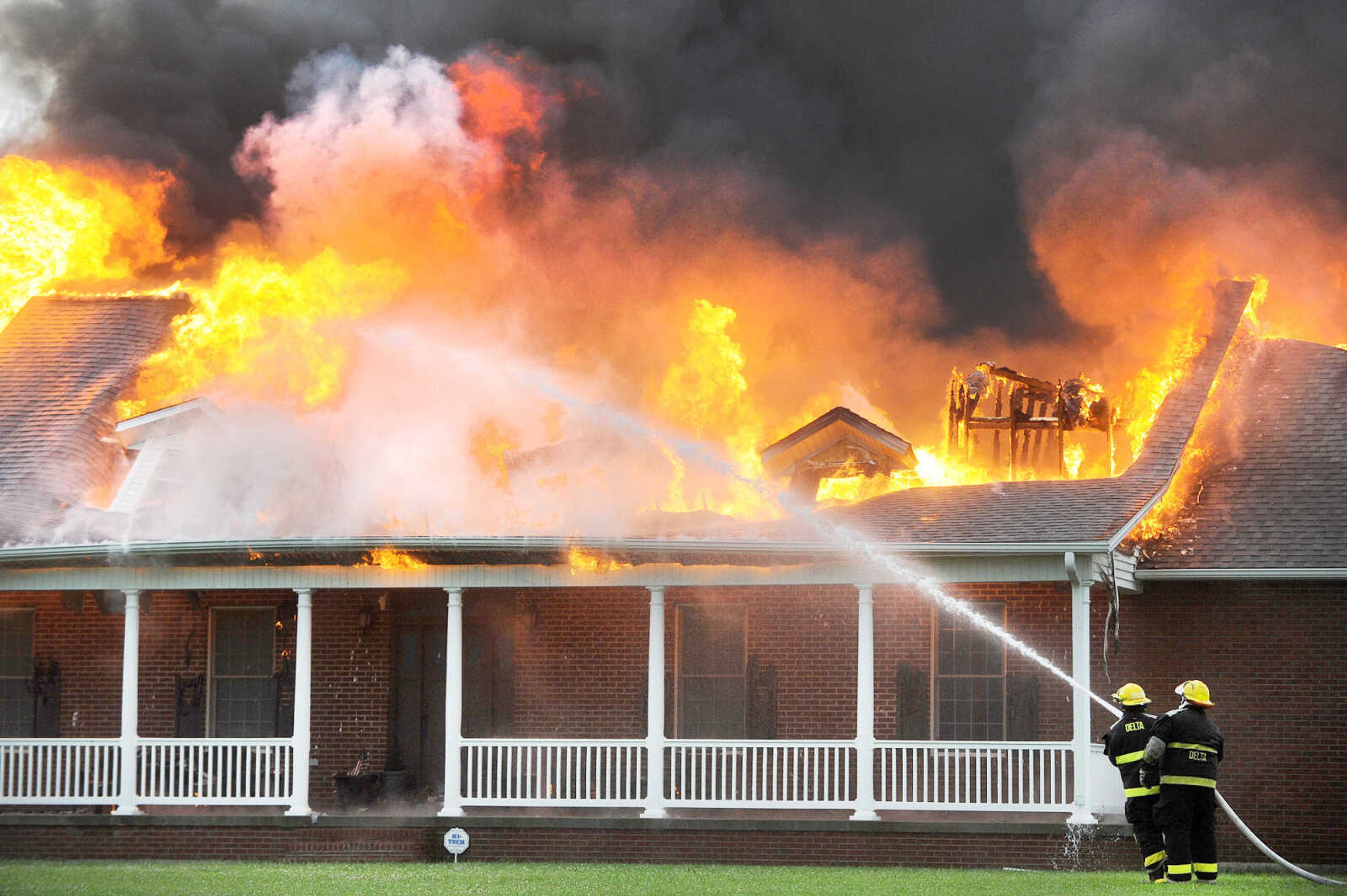 LAURA SIMON ~ lsimon@semissourian.com

Firefighters from Delta Fire Protection District battle a blaze at a house off County Road 204 in Scott County Wednesday afternoon, July 23, 2014. Fire departments from Scott City, Chaffee and New Hamburg/Benton/Commerce were also on scene to battle the fire.